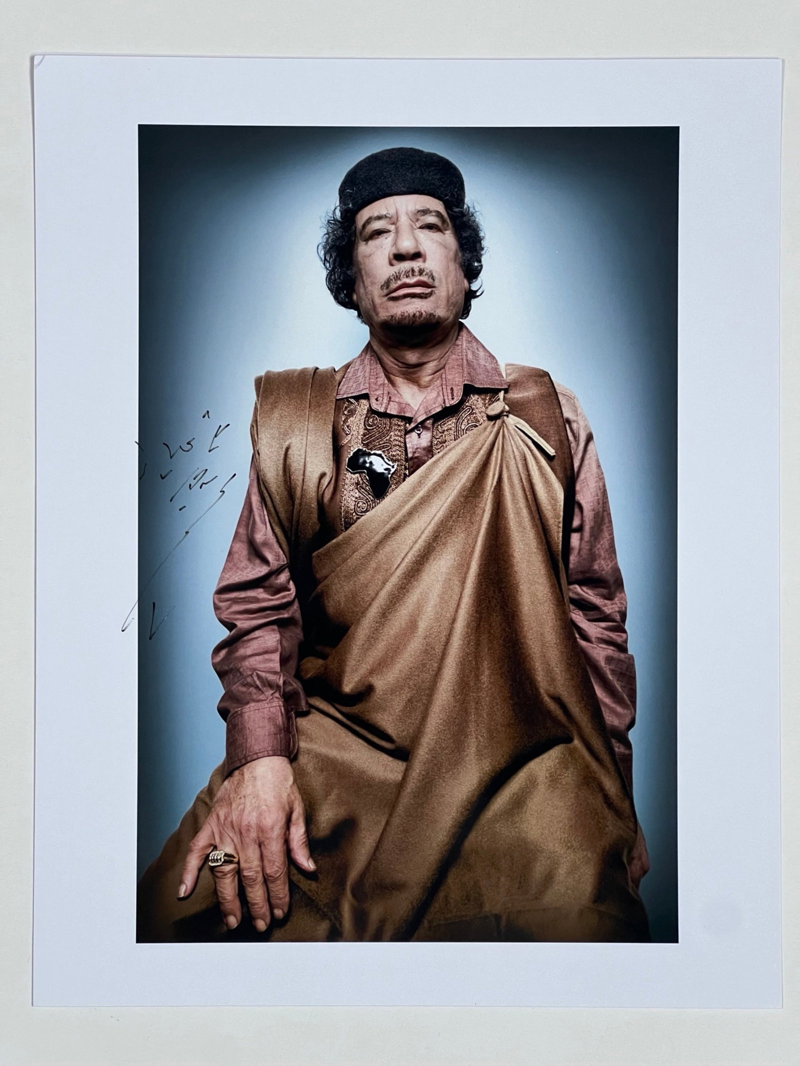 Muammar Ghadaffi Autographed 11" x 14" Photograph: Capture a moment in history with this unique collectible featuring an autographed 11" x 14" photograph of Muammar Gaddafi. Despite the complexities surrounding his legacy, this item serves as a remind