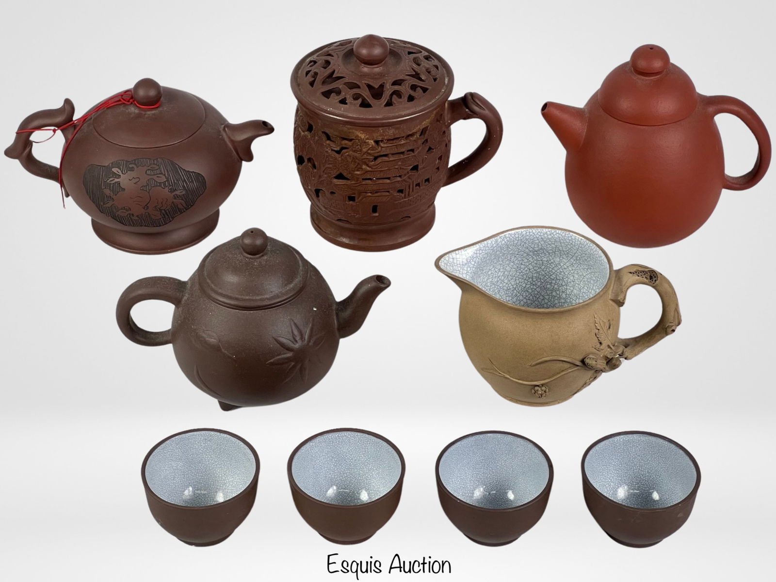 Chinese Pottery Yixing Clay Teapots & Cups: Transform your tea time into a luxurious ritual with this exquisite collection of Chinese pottery Yixing clay teapots and cups. Crafted from the renowned Yixing clay, celebrated for its porous texture