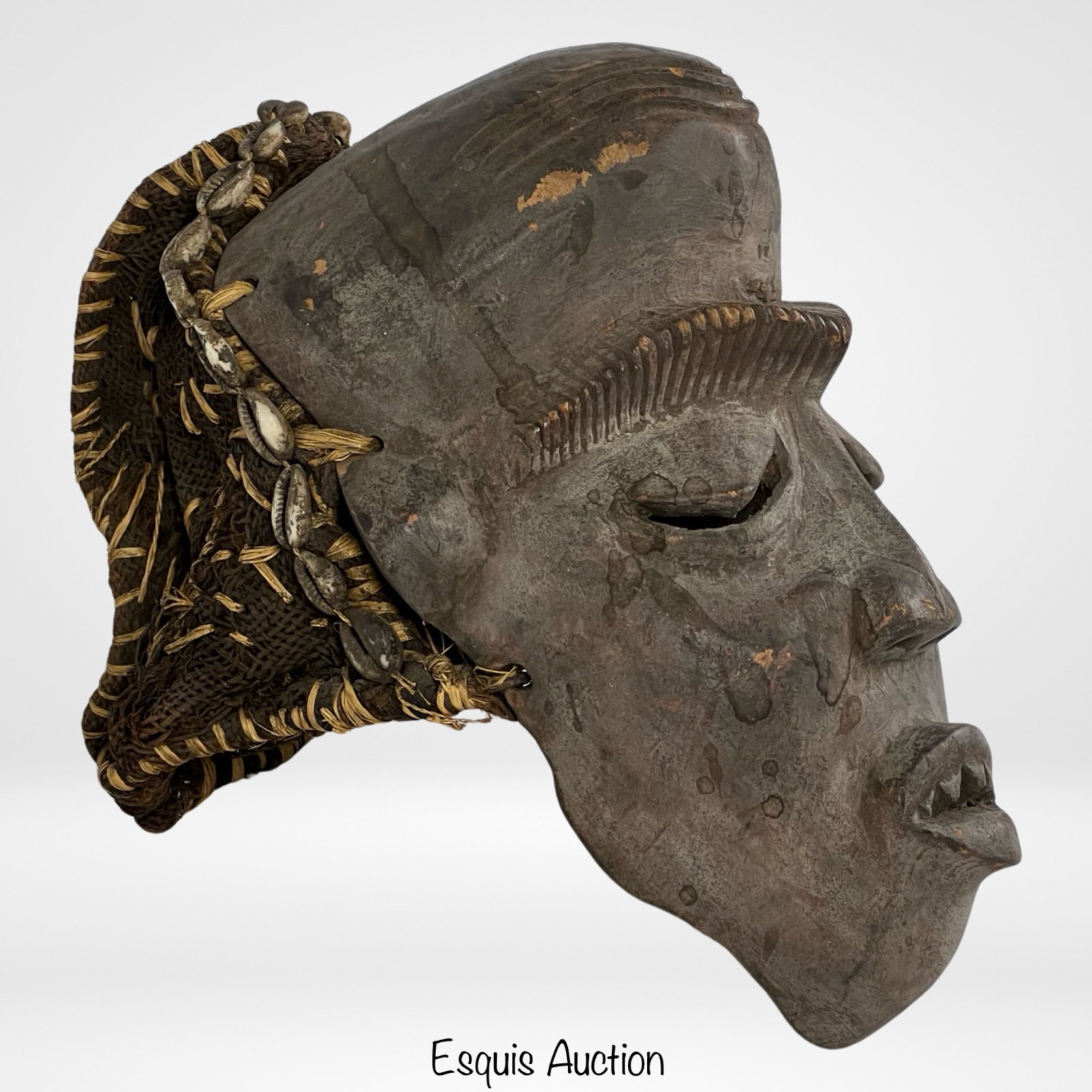 West African Nigeria Idoma Wood Carved Tribal Mask: This striking wood carved tribal mask originates from West Africa, specifically from the Idoma people of Nigeria. Dating back to the late 19th to early 20th century, this intricately crafted mask stan