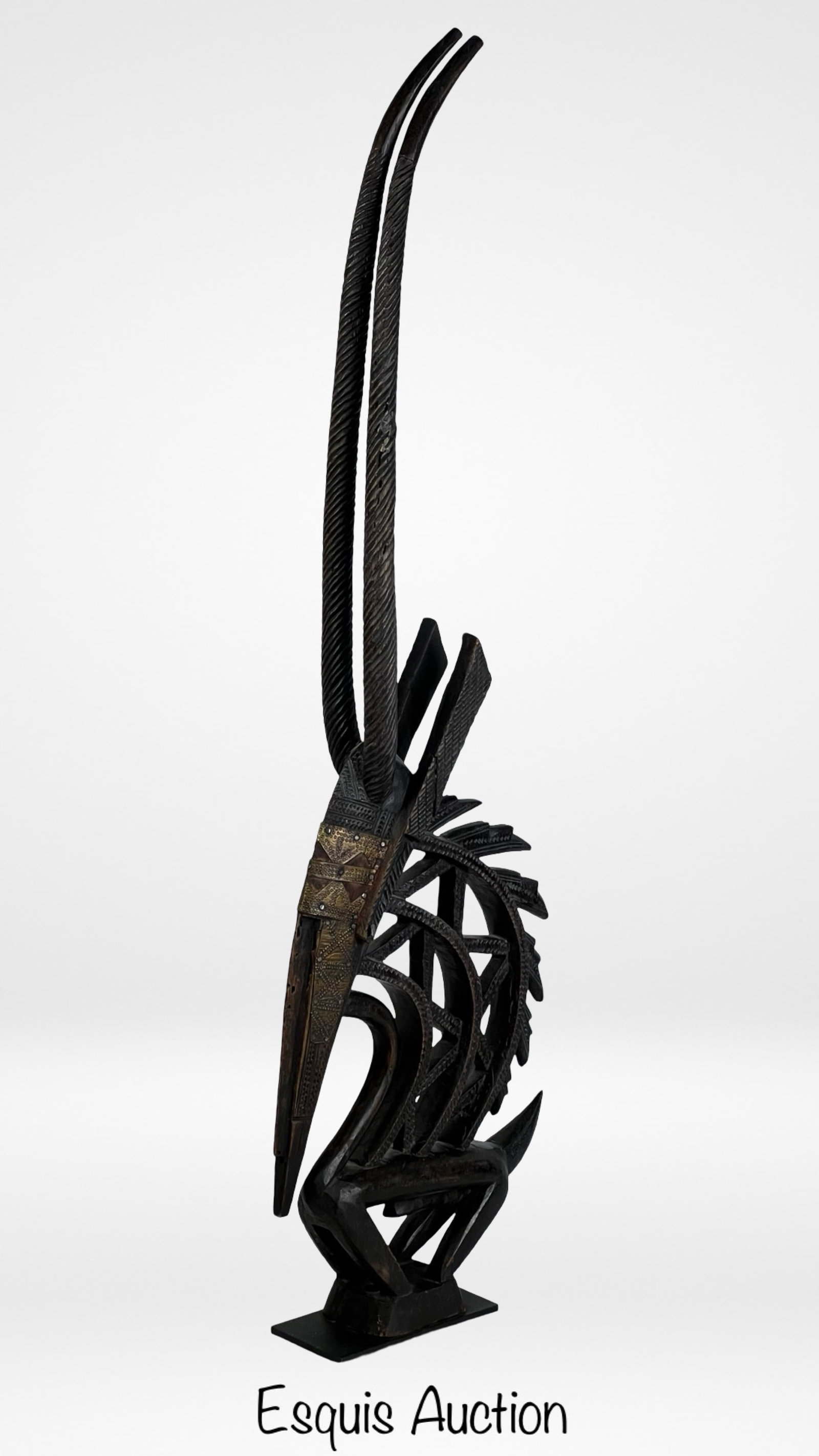 African Chi Wara Mali Dance Headdress Carved Wood: This African Tribal Chi Wara Mali Dance Headdress, mounted on a metal base, embodies the rich cultural heritage of the Bamana people of Mali. Carved from wood, it depicts the graceful form of the Chi 