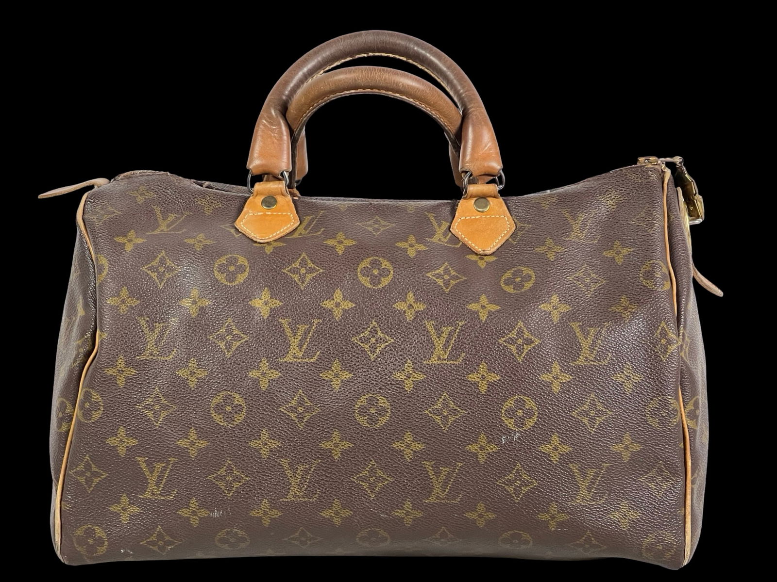 Vintage Louis Vuitton Speedy Travel Bag from 1970s: Vintage Louis Vuitton Speedy Travel Bag from 1970s. 13" x 10" x 7'. Shows time related wear, "made in USA" tag ripped off during photoshoot.