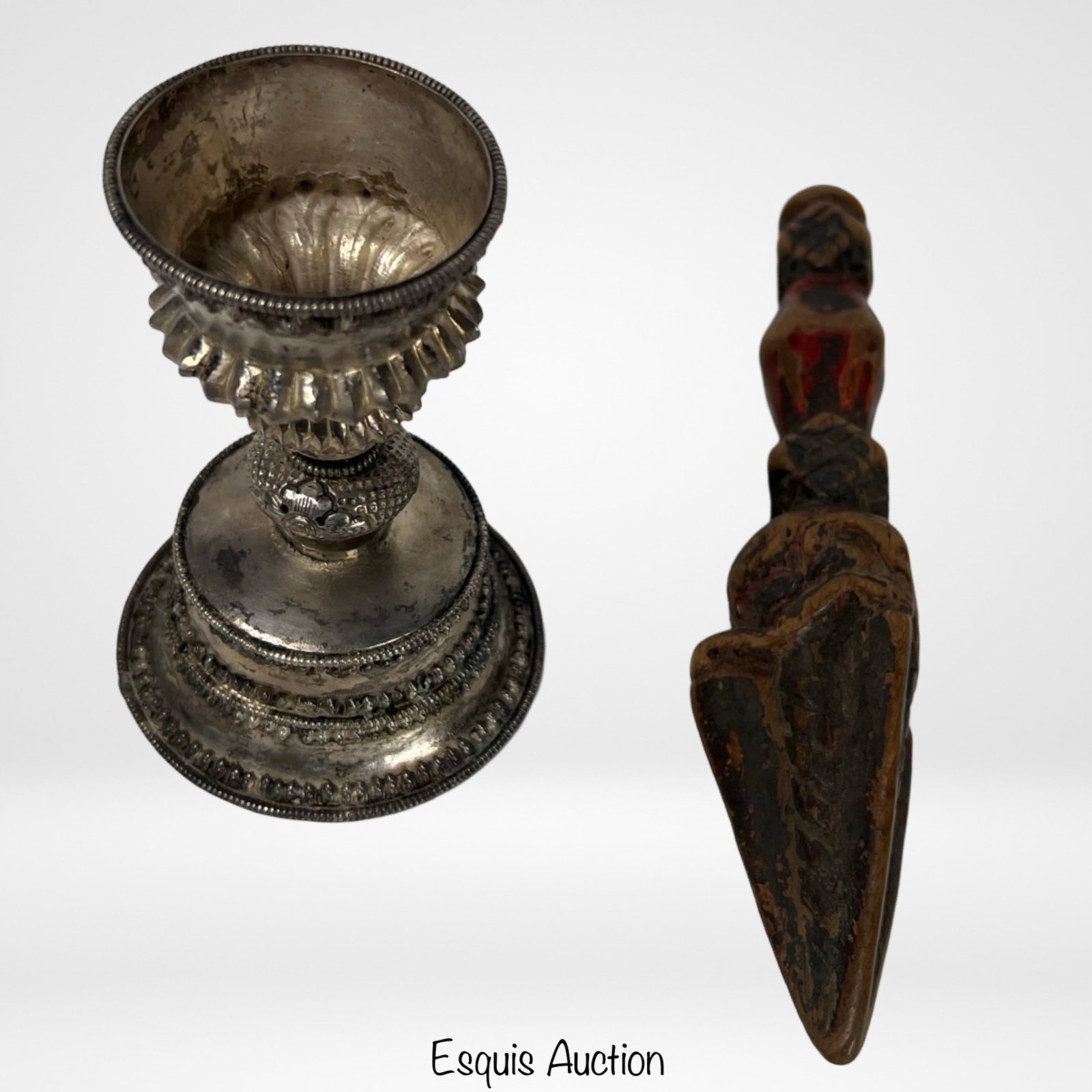 Antique Silver Chinese/Tibetan Yak Butter Lamp & F: Antique Silver Chinese/Tibetan Yak Butter Lamp and Antique Wood Carved Tibetan Fertility Figure.Both items in this lot reflect the rich cultural heritage and spiritual traditions of Tibetan and Chines