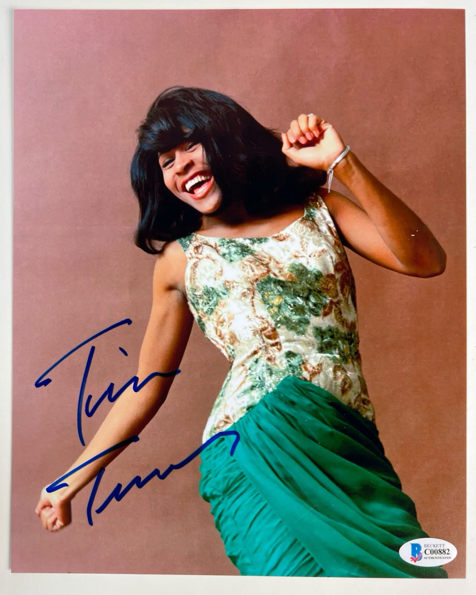 Tina Turner Autographed/ Signed Photograph: This 8" x 10" photograph features the legendary Tina Turner, renowned as the "Queen of Rock 'n' Roll." Captured in an iconic pose, Tina Turner exudes her signature energy and charisma. The photograph