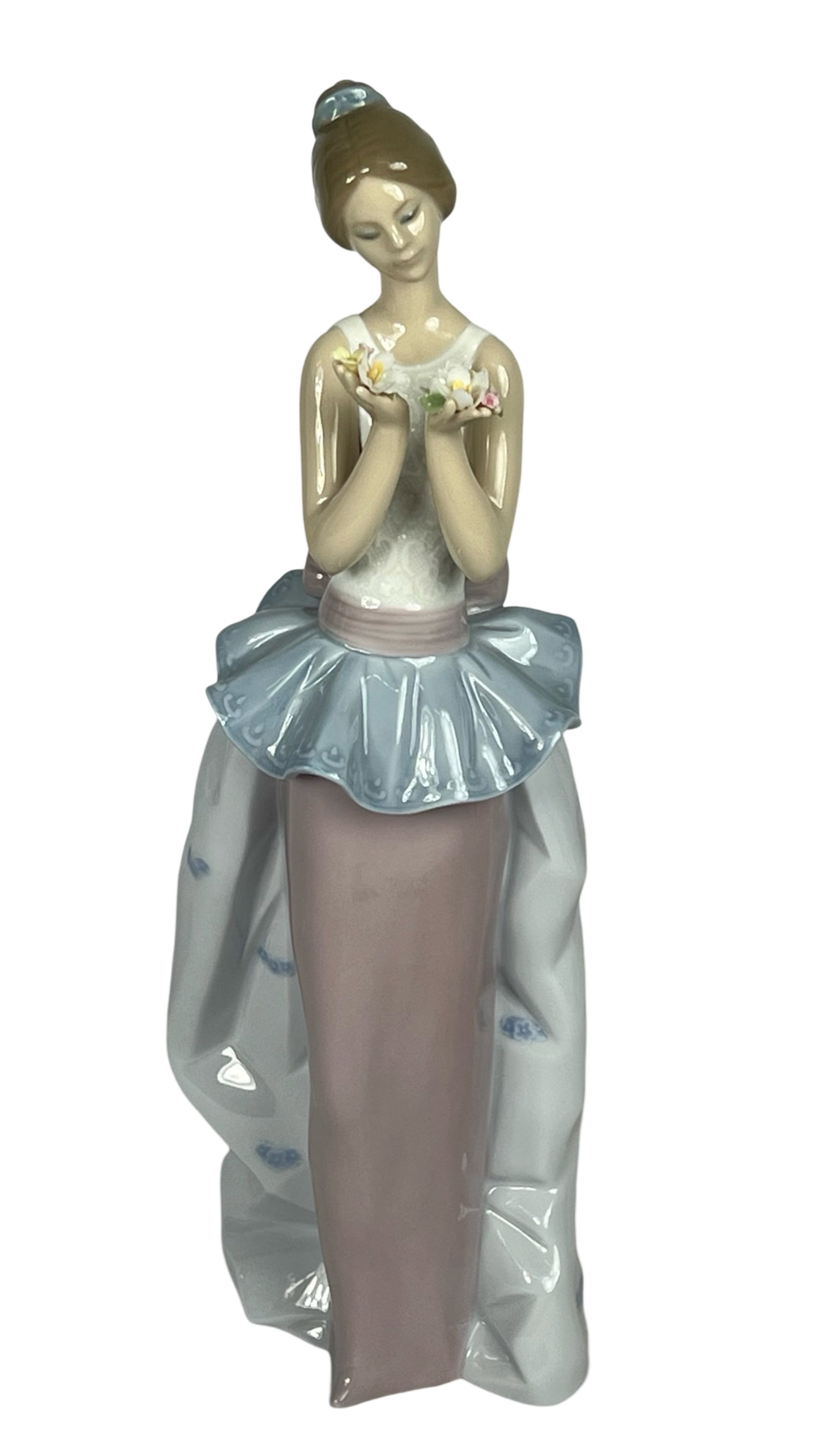 Lladro "An Expression of Love" 6592 Figurine: This beautiful Lladro porcelain figurine, titled "An Expression of Love" (6592), stands at 14 inches tall. The sculpture depicts a serene young woman holding a delicate bouquet of flowers close to her