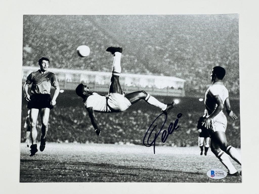 Pele Autographed Soccer Photograph: Celebrate the legacy of football greatness with this 8 1/2" x 11" photograph, signed by the legendary Pele.This captivating image immortalizes Pele, the iconic Brazilian footballer whose unparalleled 
