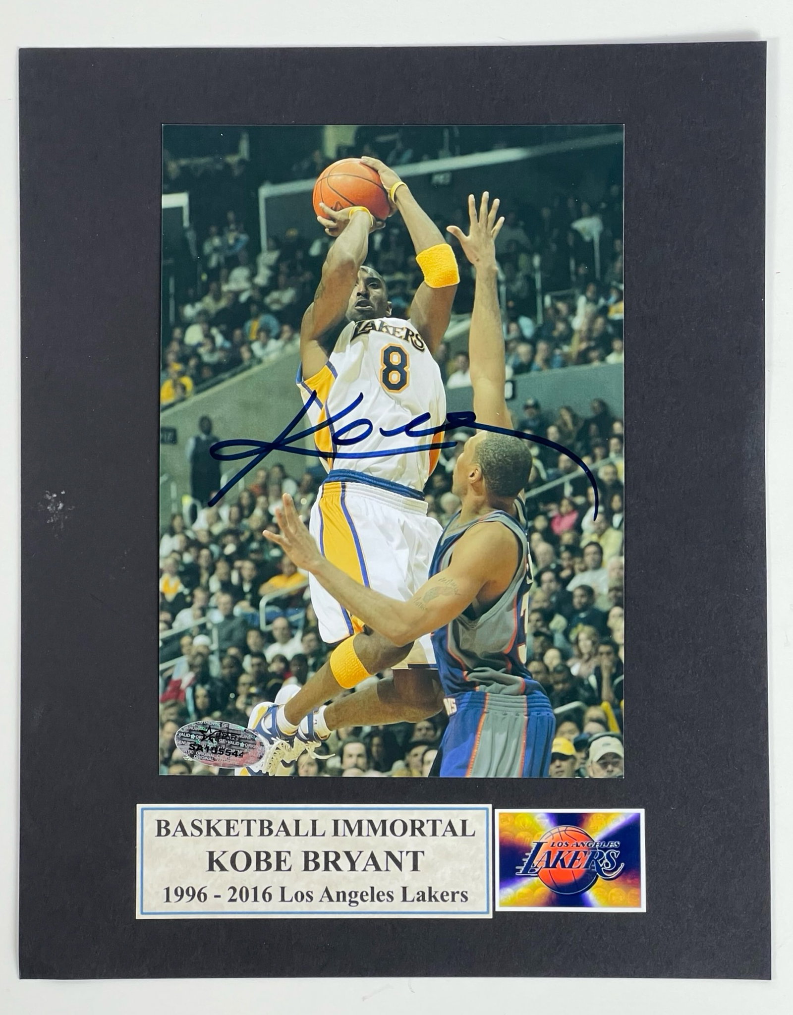 Kobe Bryant Autographed/ Signed Photograph: Capture the legacy of basketball icon Kobe Bryant with this autographed 7" x 5" photograph, elegantly mounted on an 8" x 10" matting. This stunning display piece commemorates Bryant's remarkable caree