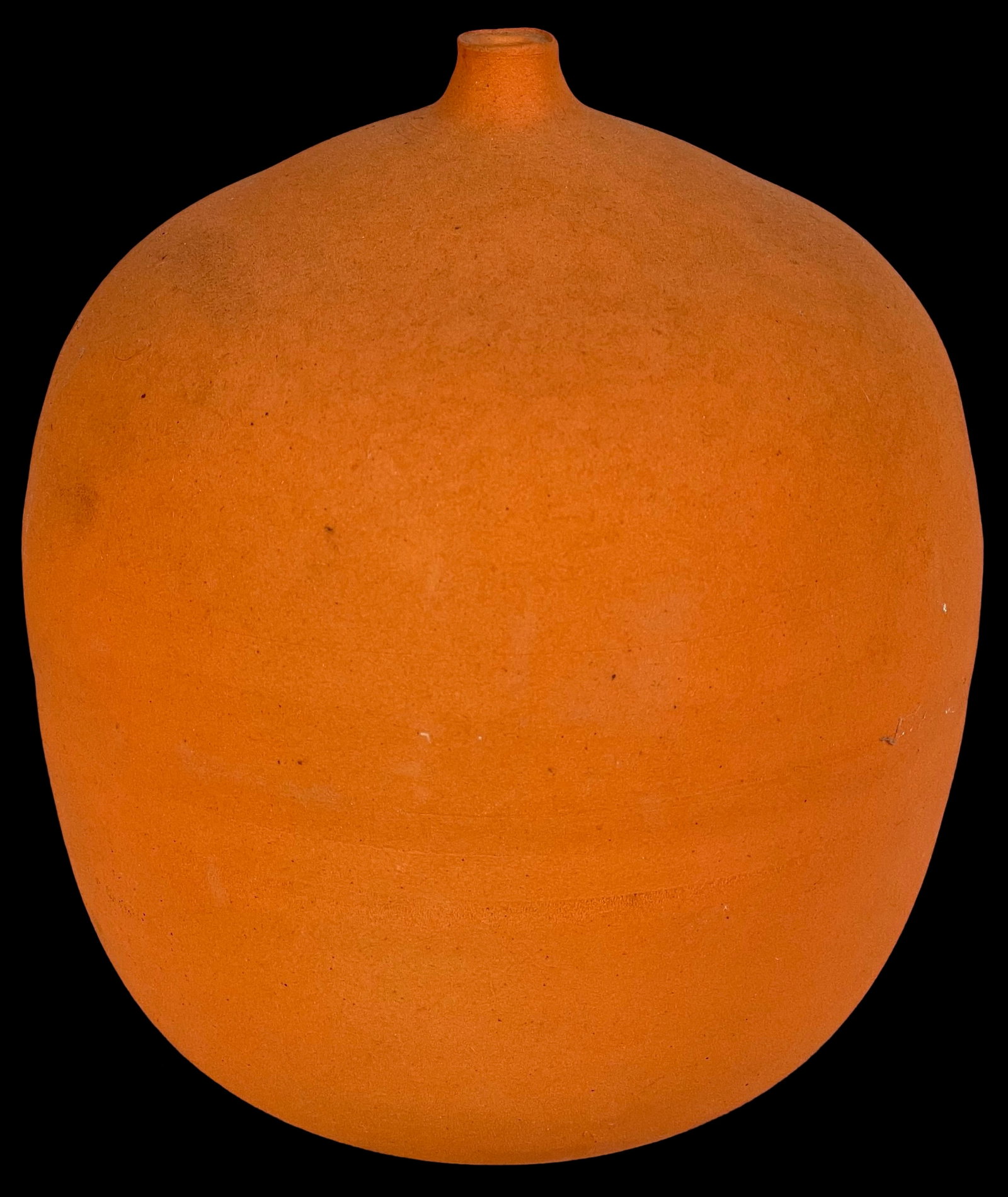 Ryan J. Ruddie Deep Orange Art Pottery Vase: This exquisite deep orange art pottery vase by Ryan J. Ruddie stands at 7 inches tall. The vase showcases a minimalist design with a smooth, matte finish that highlights the rich, warm hue of the pott
