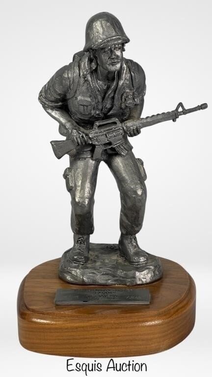 Michael Ricker Vietnam Soldier LE Pewter Sculpture: "The Vietnam Soldier Chad" Limited Edition Pewter Sculpture by Michael Ricker is a poignant and meticulously crafted piece of art. Standing at 10" tall, it captures the essence of the Vietnam War era