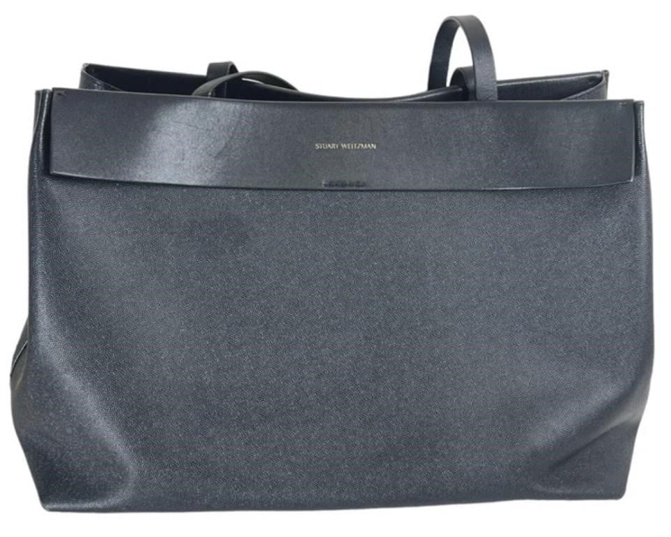 Stuart Weitzman Sybil Spanish Leather Tote Bag: Experience timeless elegance and practicality with the Stuart Weitzman Sybil Tote Bag, crafted from premium Spanish leather in a sleek black color.This luxurious tote bag offers both style and functio