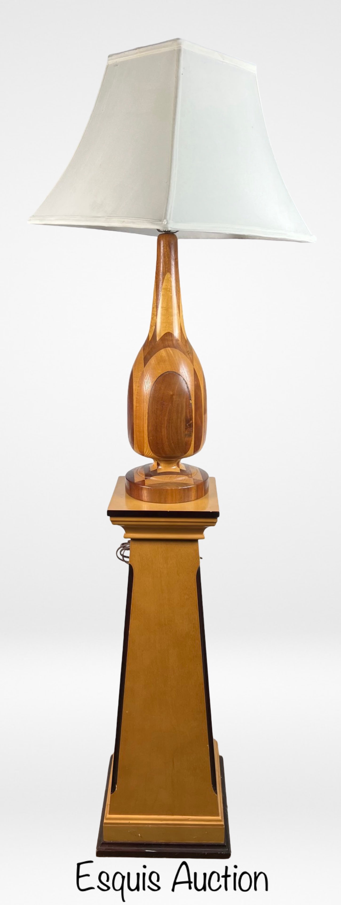 Turned Patchwork Wooden Table Lamp on Pedestal: This elegant table lamp features a turned patchwork wooden base, showcasing a variety of wood tones and grains meticulously crafted together. The Lamp is sitting on Maple Wood Pedestal. Lamp is 30" ta