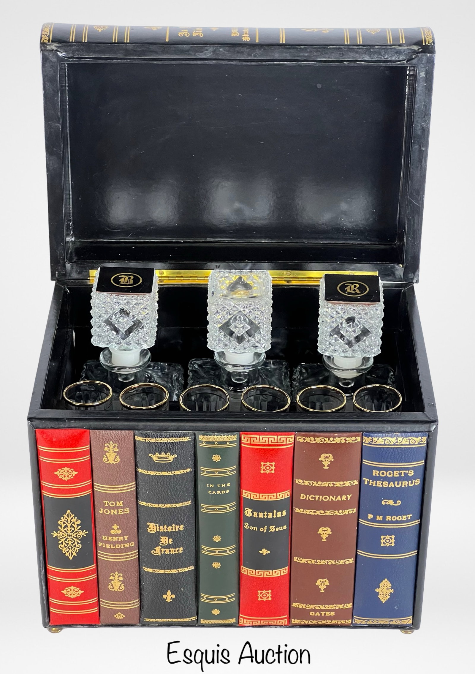 Hidden Bar in Faux Books Box: An exquisite hidden bar set disguised as a collection of classic literature. The box, designed to resemble a row of leather-bound books, opens to reveal three crystal decanters and six matching glasse