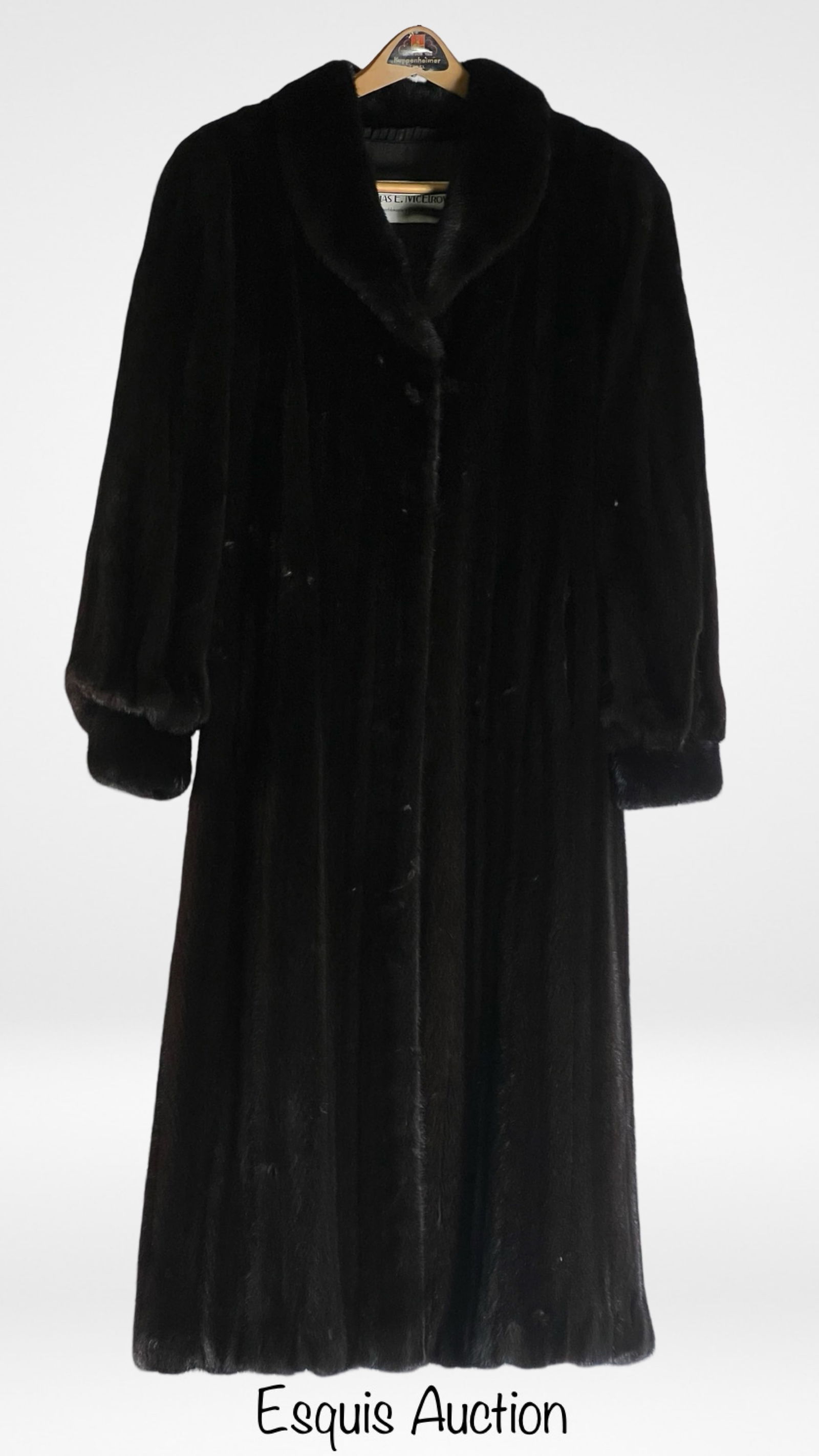 Vintage Black Female Mink Fur Coat: This luxurious vintage mink fur coat by Thomas E. McElroy of Chicago is a classic piece of outerwear. The coat features a rich, deep black color and a soft, silky texture, making it perfect for stayin