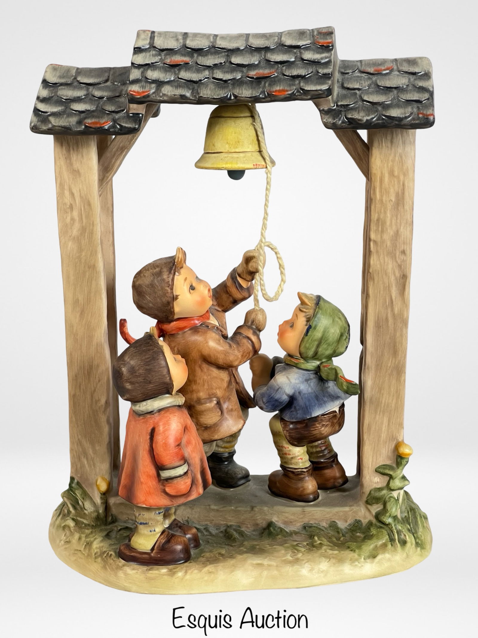 Hummel Goebel "Let's Tell the World" Figurine: This delightful Hummel Goebel figurine, titled "Let's Tell the World," captures the charming innocence and joy of childhood. Depicting three young children gathered around a bell, each child is meticu