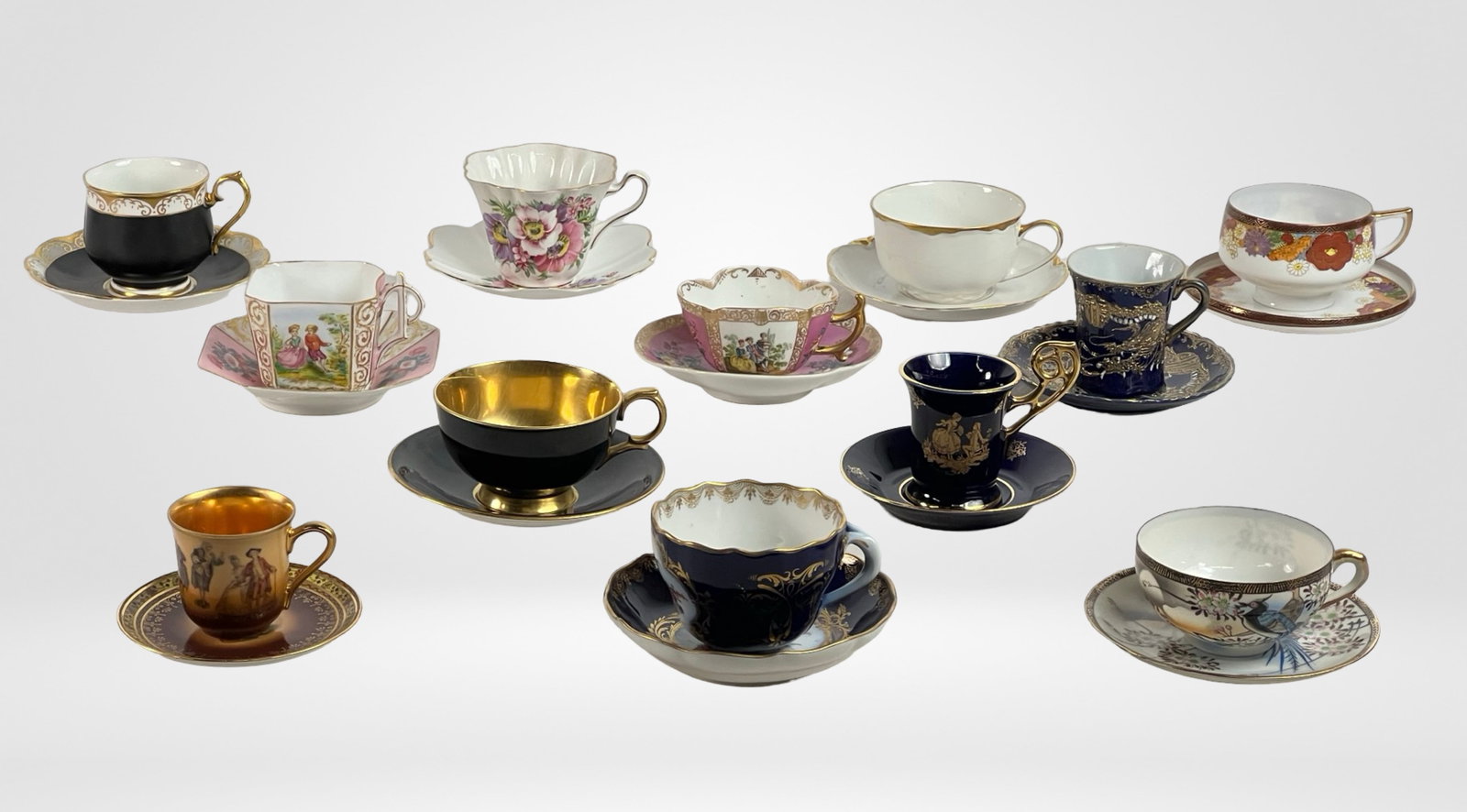 Collection of Demitasse Cups- Meissen, Limoges: This exquisite lot features a diverse collection of 12 vintage and antique demitasse cups and saucers. Each piece showcases intricate designs, rich colors, and fine details, reflecting a variety of st
