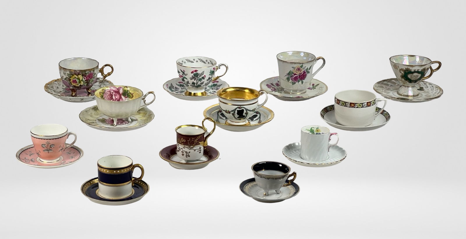 Collection of Demitasse Cups- Meissen, KPM, Aynsle: This exquisite lot features a diverse collection of 12 vintage and antique demitasse cups and saucers. Each piece showcases intricate designs, rich colors, and fine details, reflecting a variety of st