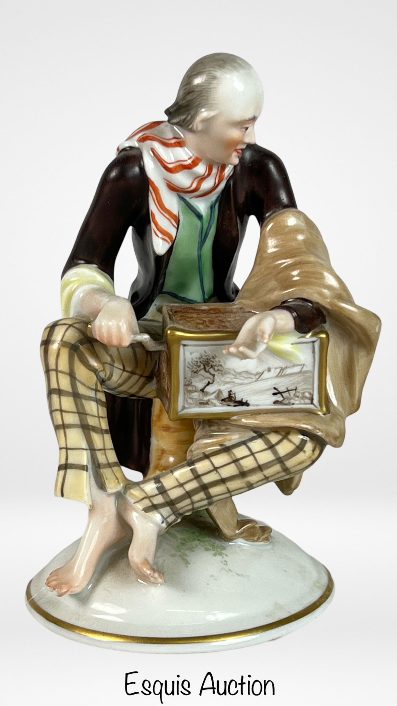 Vienna Augarten Porcelain Organ Grinder Figurine: A charming porcelain figurine by the esteemed Vienna Augarten, depicting a street organ grinder. The figure is intricately painted, showcasing the grinder in a moment of performance, his instrument de