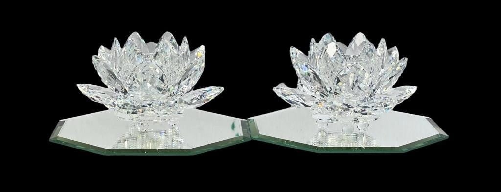 Pair of Swarovski Crystal Waterlily Candleholders: These exquisite candleholders are crafted in the shape of waterlilies, featuring beautifully faceted petals that reflect light brilliantly. Each waterlily is set on an octagonal mirrored base, enhanci