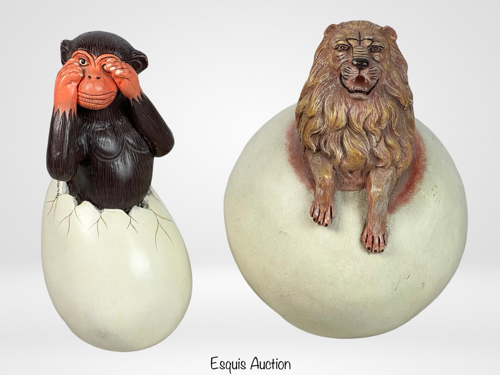 J. Camarena-Parra Mexican Folk Art Sculptures: A delightful pair of Mexican Folk Art sculptures by artist J. Camarena-Parra. These unique pieces depict a monkey and a lion emerging from cracked eggs, symbolizing birth and new beginnings. The monke