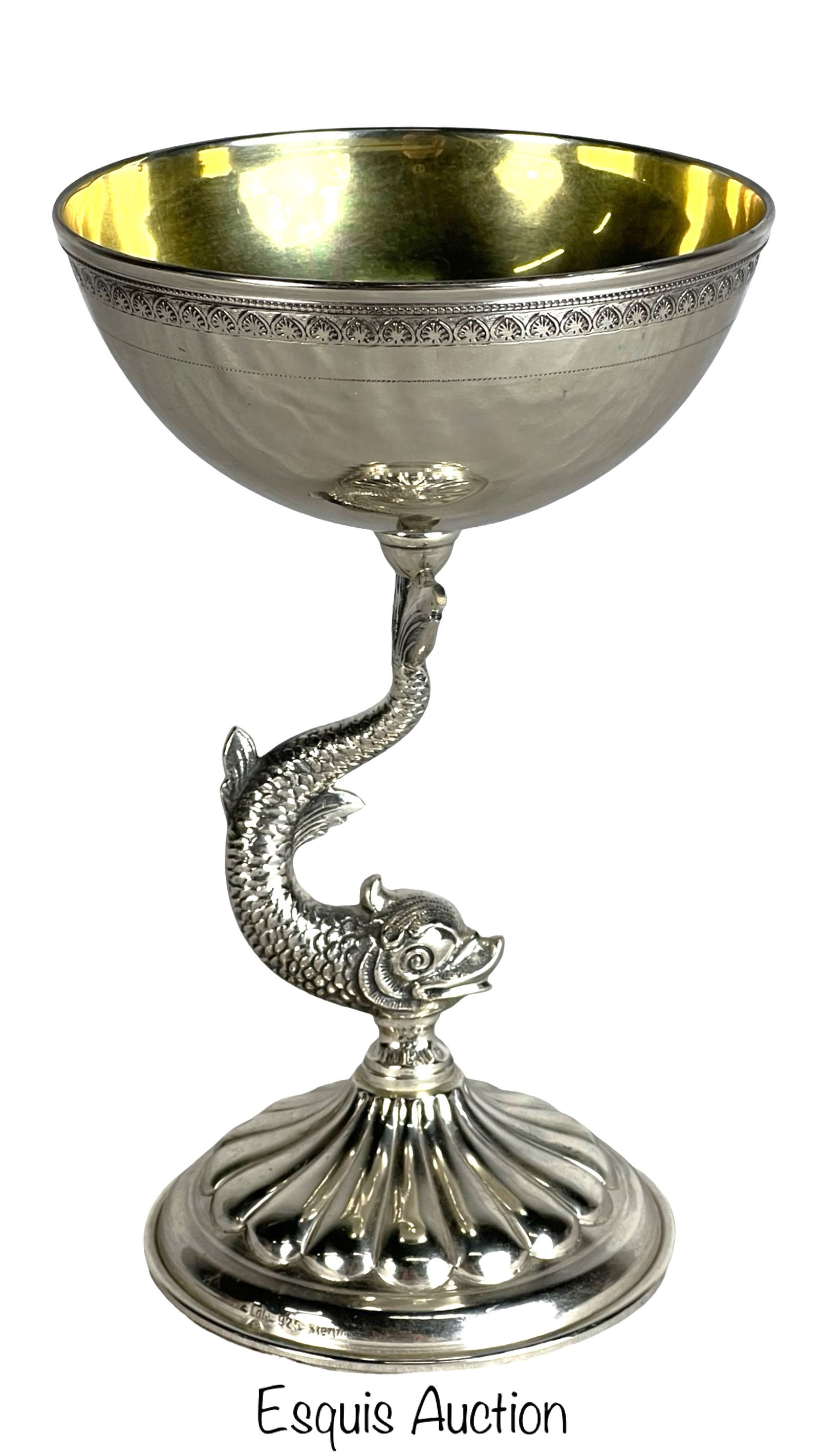 Sterling Silver Goblet with Dolphin Stem by Lale: This elegant sterling silver goblet stands 7 inches tall with a 4 1/4-inch diameter. The bowl features a gilded interior and a decorative border along the rim. The stem is intricately designed as a st