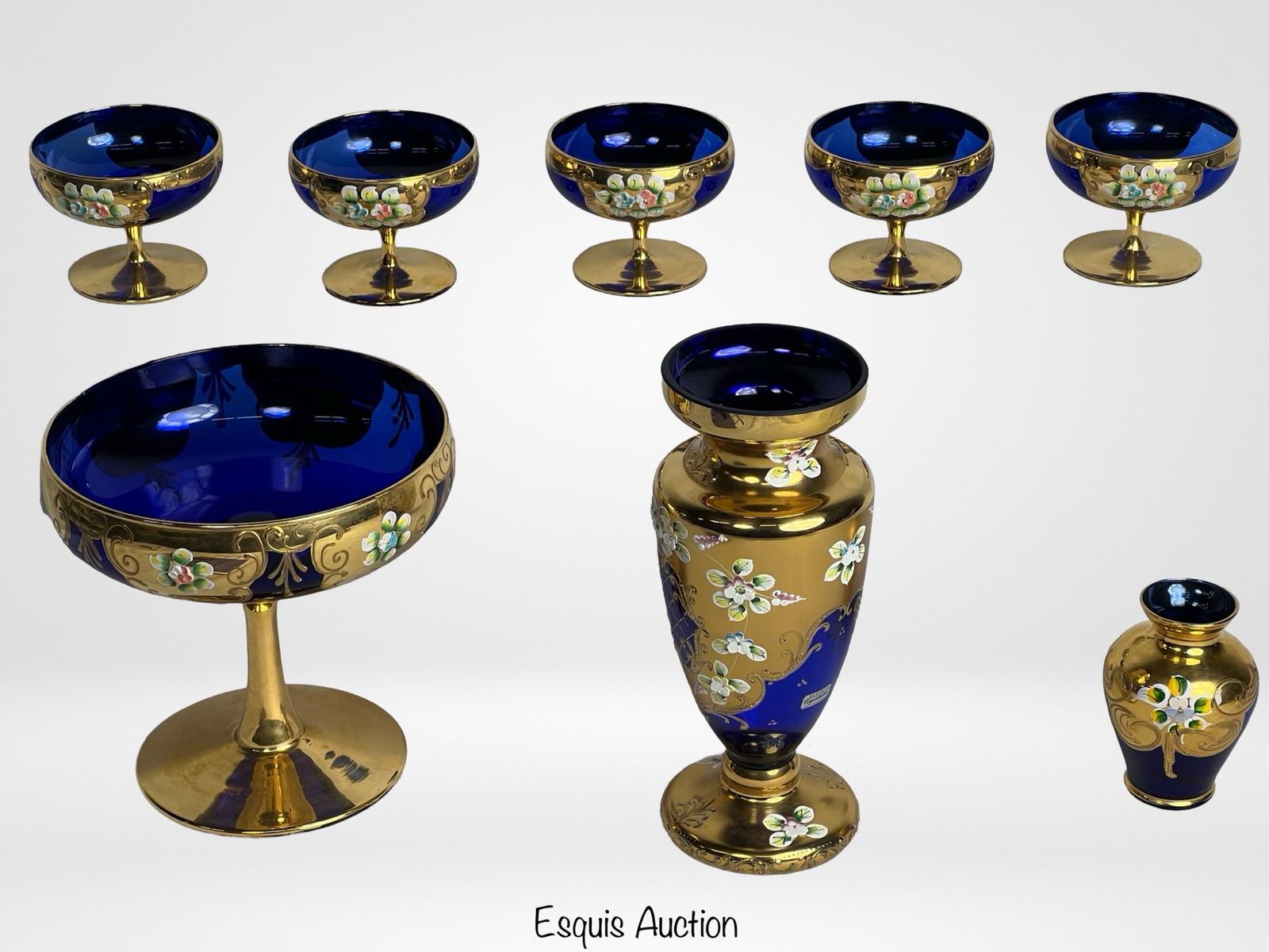 Bohemian & Venetian Murano Art Cobalt Glass: This unique lot features an exquisite collection of Bohemian and Venetian Murano glass pieces. The set includes cobalt blue champagne goblets and vases, all elegantly hand-painted with 24K gold accent