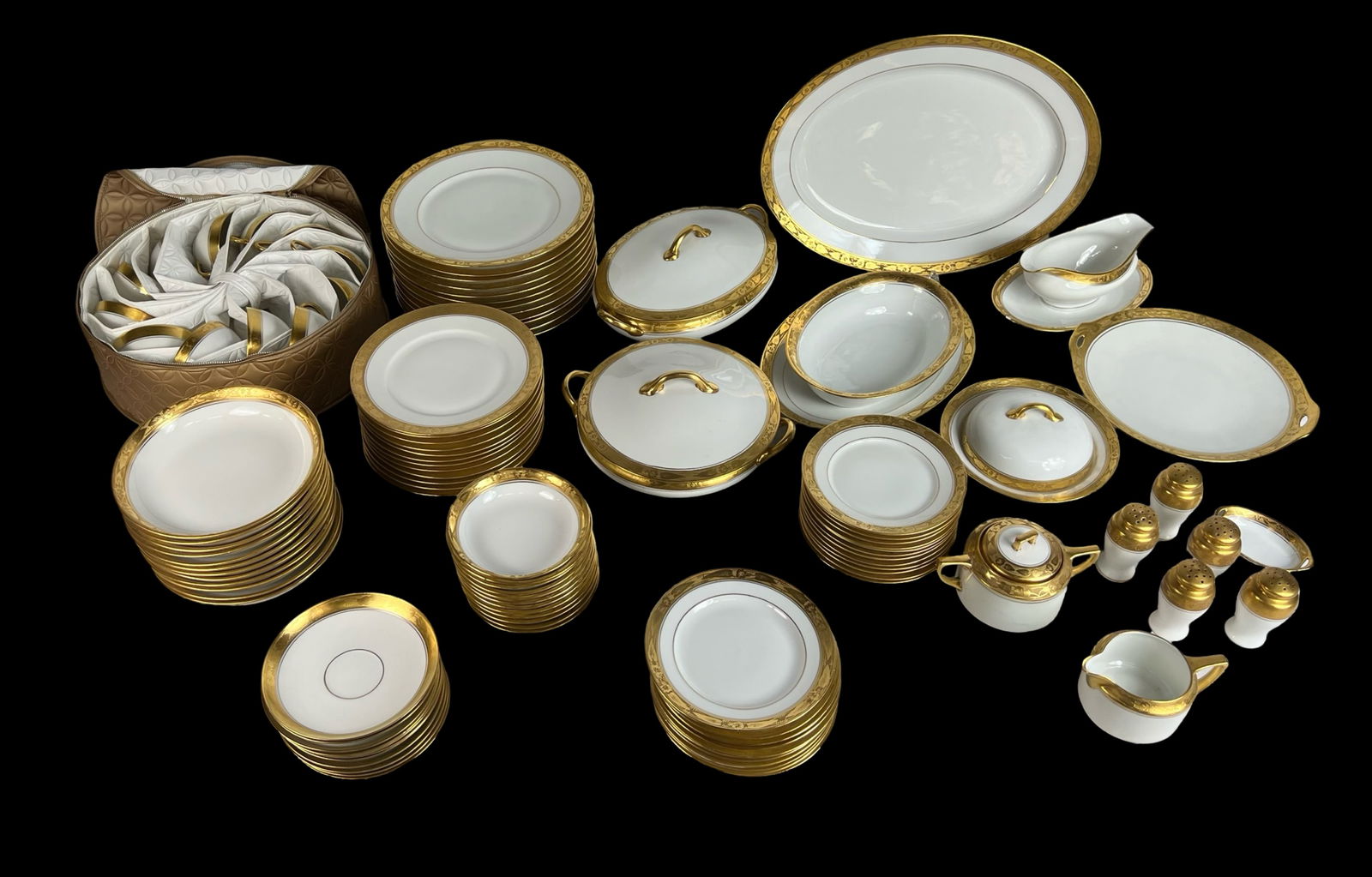 Hutschenreuther Gold Trimmed China Set for 12: A stunning Bavarian porcelain service for 12, featuring luxurious gold gilt trim. The set includes 12 dinner plates, 12 salad plates, 12 dessert plates, 12 soup bowls, 12 side bowls, 12 cups, 11 sauce