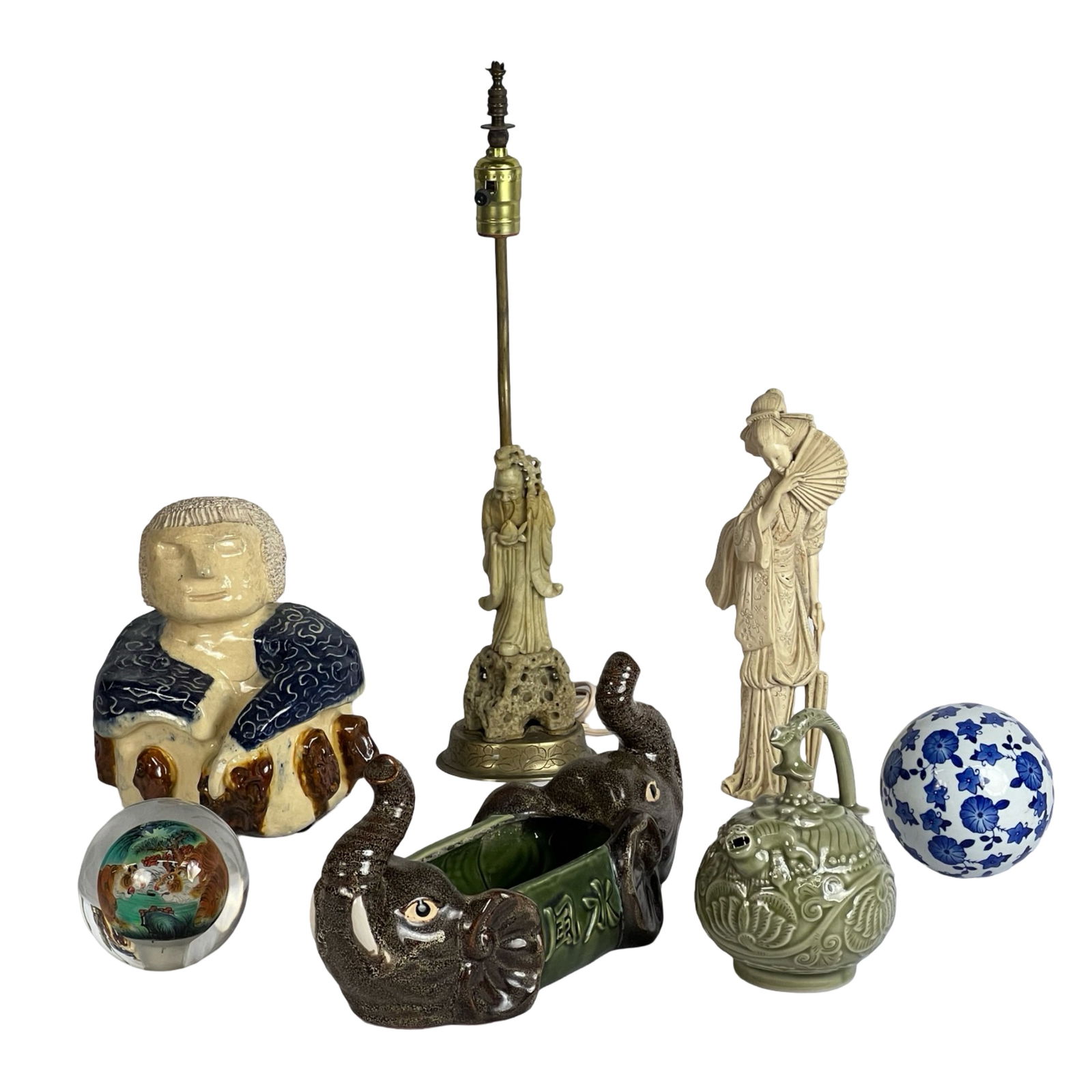 Group of Chinese Decorative Objects: A collection of Chinese and Asian-inspired decorative pieces. This eclectic lot includes a vintage celadon teapot adorned with ornate carvings, a soapstone carved lamp featuring a traditional figure,