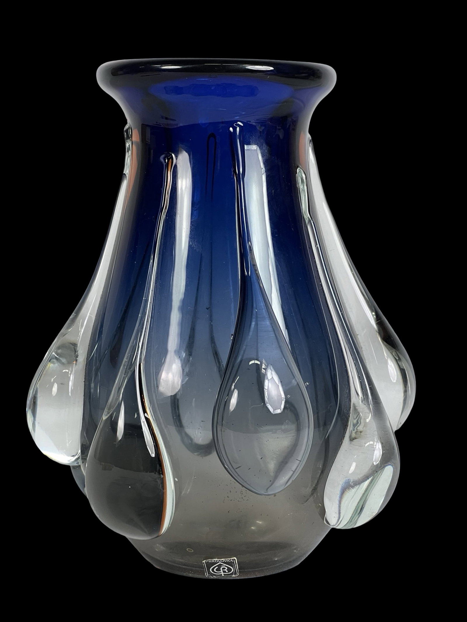 Skrdlovice Art Glass Vase by Pavel Hlava 1970's: A striking Skrdlovice art glass vase designed by renowned Czech designer Pavel Hlava in the 1970s. The vase showcases Hlava?s signature style with its deep blue hue and intricate clear glass teardrop-
