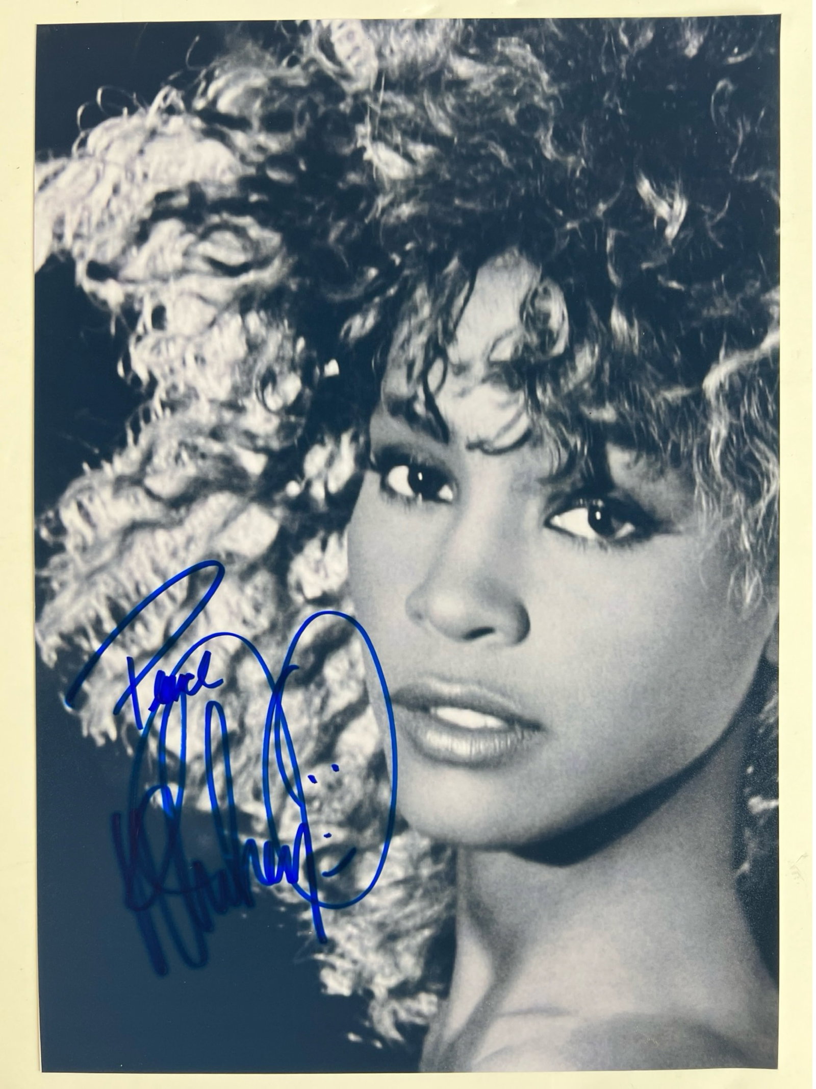 Whitney Houston Autographed/ Signed Photograph: This stunning black and white photograph of the legendary Whitney Houston features her bold autograph in blue ink. The image captures Houston?s captivating beauty and charisma, showcasing her iconic c