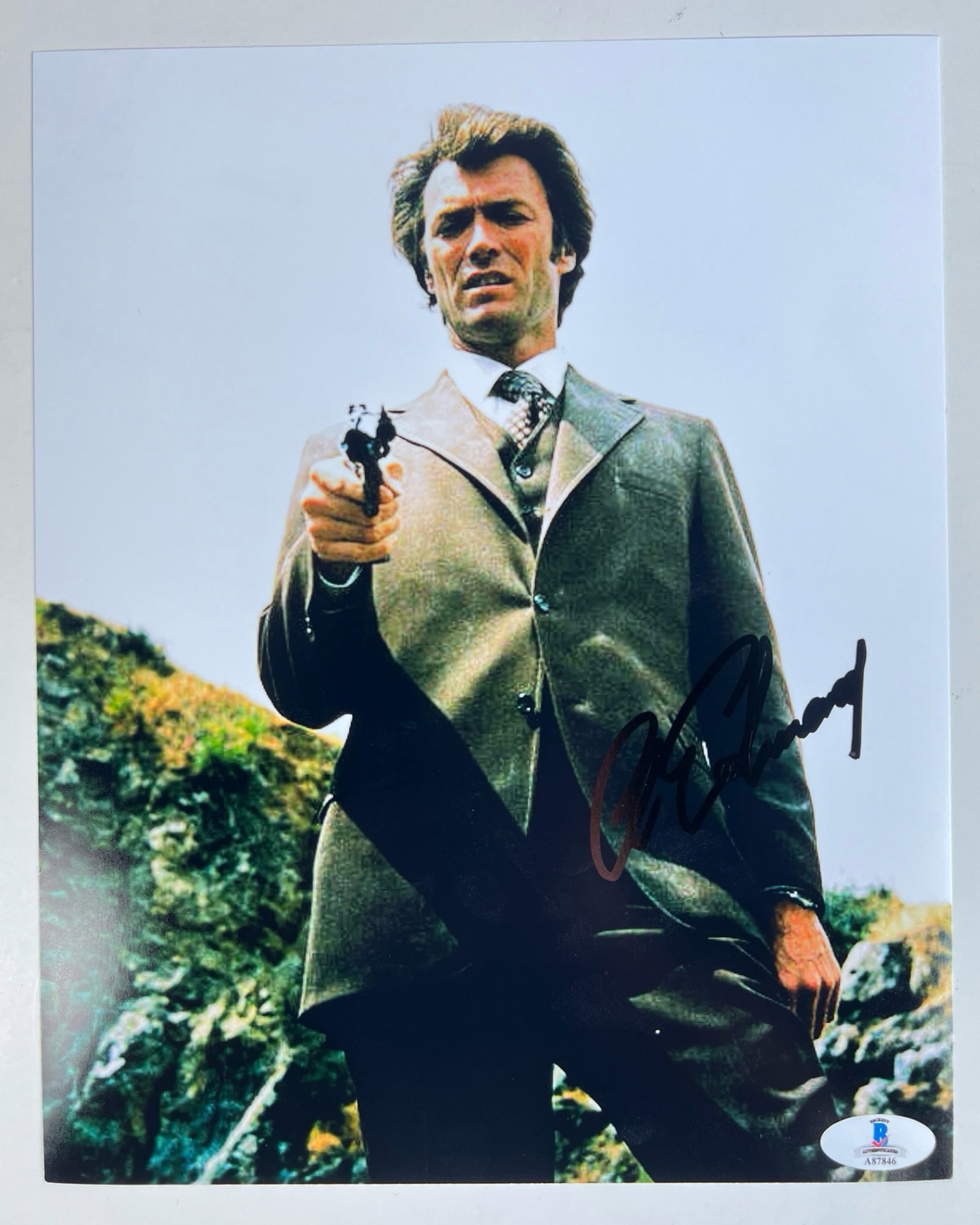 Clint Eastwood Autographed Dirty Harry Photograph: A stunning autographed 8" x 10" photograph of Clint Eastwood as Dirty Harry, featuring the actor in one of his most iconic roles. Eastwood's signature is boldly placed on the image, capturing the lege