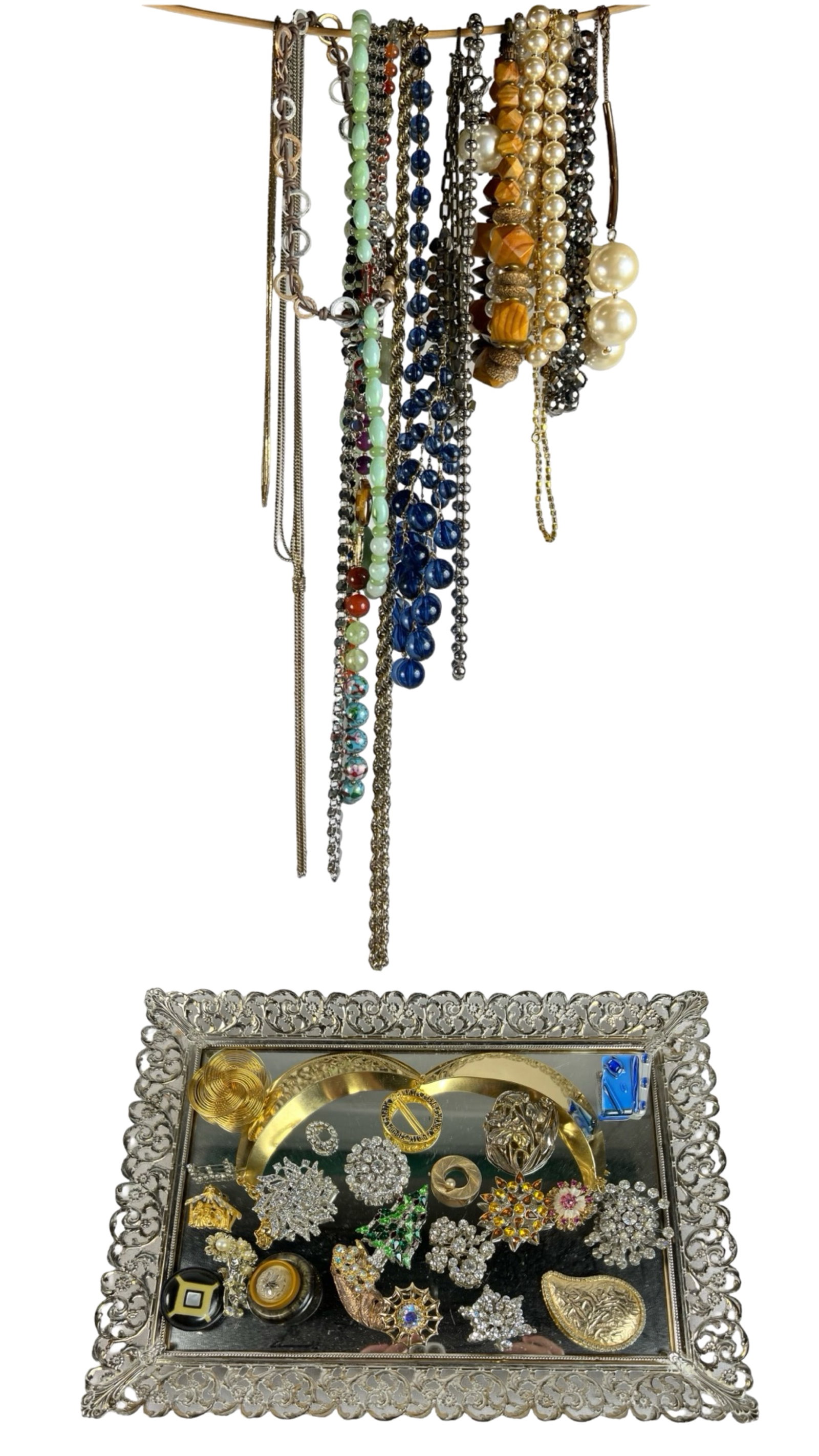 Assortment of Vintage Jewelry: A curated collection of vintage jewelry featuring an array of necklaces, brooches, and bracelets. This assortment includes beaded necklaces of various materials, colorful brooches, and elegant pins in