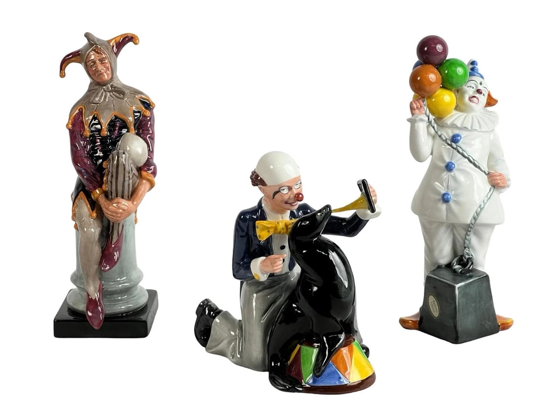 Royal Doulton Porcelain Figurines- Jester, Clown,: Royal Doulton Clown Figurine Collection featuring "The Jester" HN 2016, "Mister Pennyfarthing" HN 2325, and "Pagliacci" HN 2884. Each figurine is crafted in fine porcelain, hand-painted in vibrant det