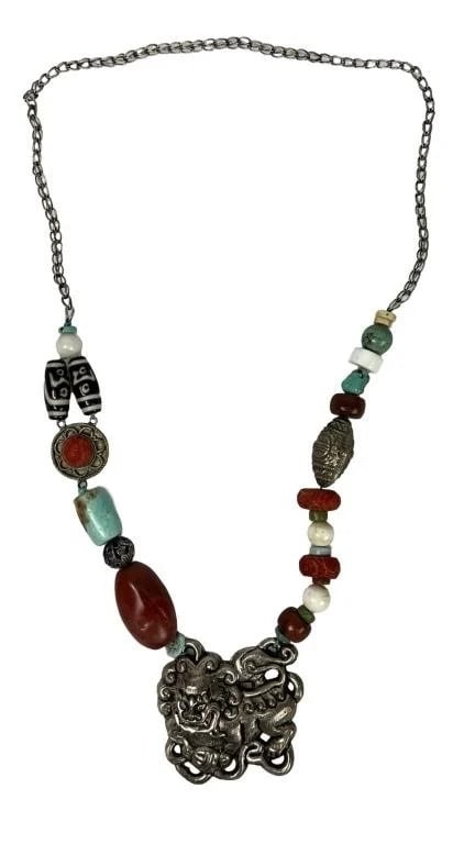 Massive Tibetan Multi-Stone Necklace w/ Foo-Dog Pe: This massive Tibetan necklace features a striking combination of multi-stone beads and a prominent Foo-Dog pendant. The necklace measures 30 inches in length, with the pendant itself measuring 3 inche