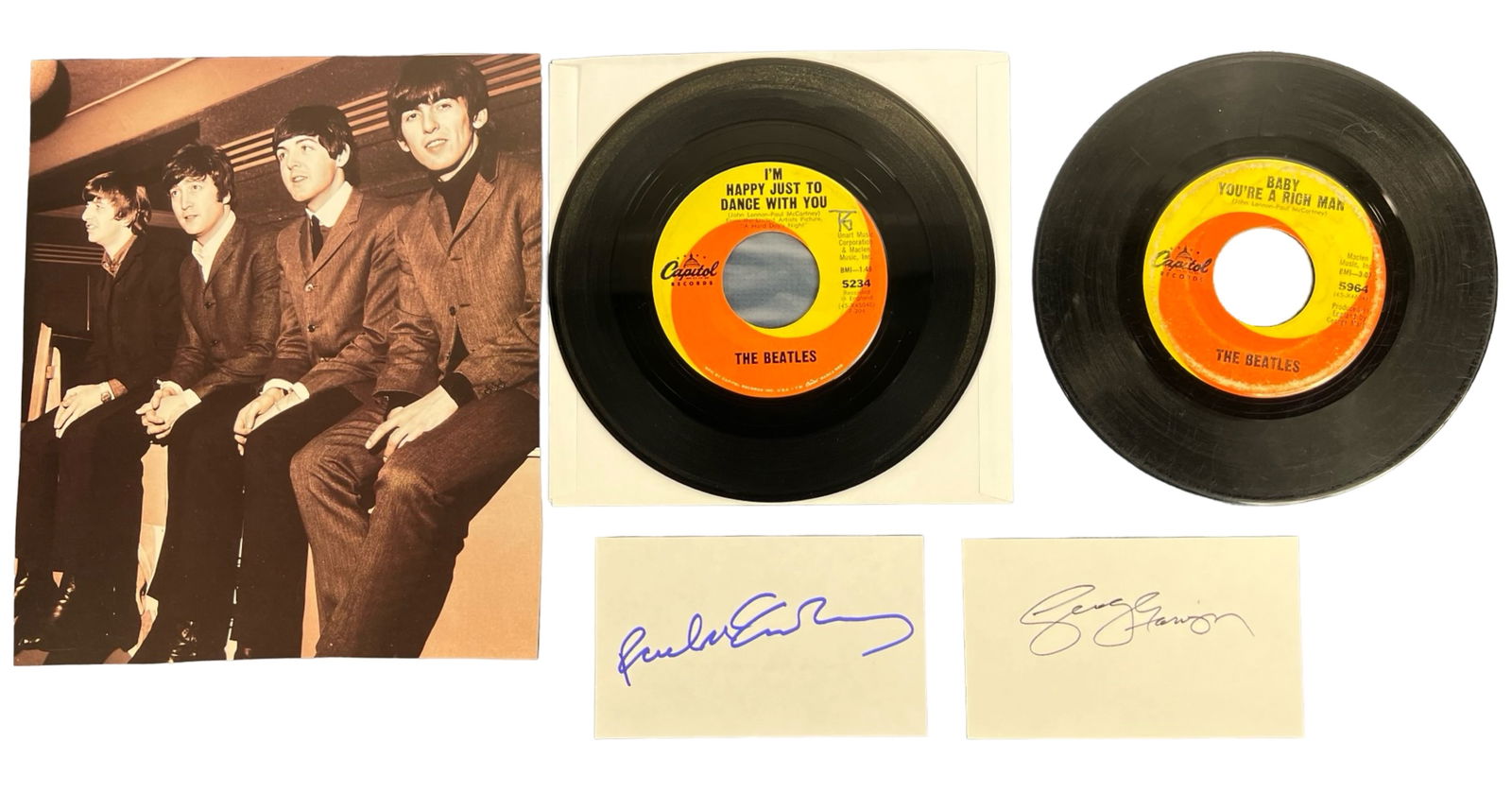 The Beatles- McCartney & Harrison Autographs: A remarkable collectible set featuring autographs of Paul McCartney and George Harrison on individual 3" x 5" index cards. This lot also includes two iconic Beatles 45rpm records: "I'm Happy Just to D