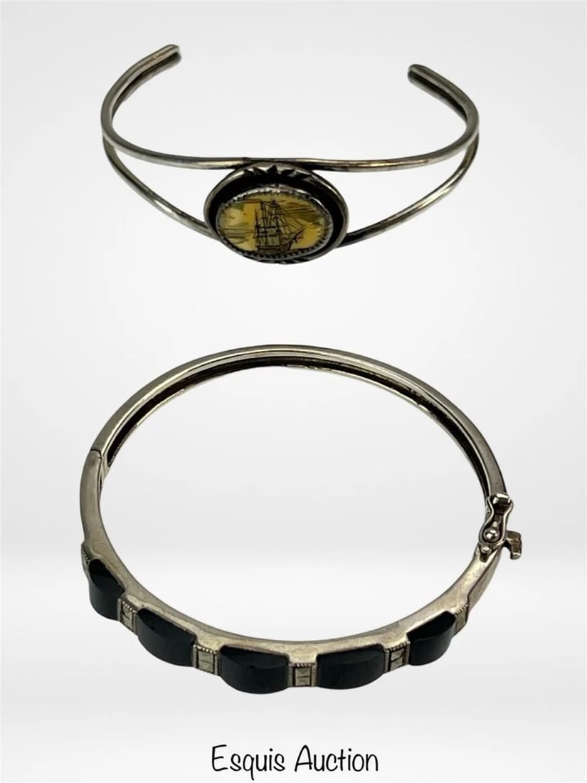 Two Lady's Sterling Silver Bracelets- Scrimshaw &: Two Lady's Sterling Silver Bracelets- Scrimshaw & Onyx. Measure 2 1/2" x 2" and 2 1/2" x 2 1/2".Both are in good condition.
