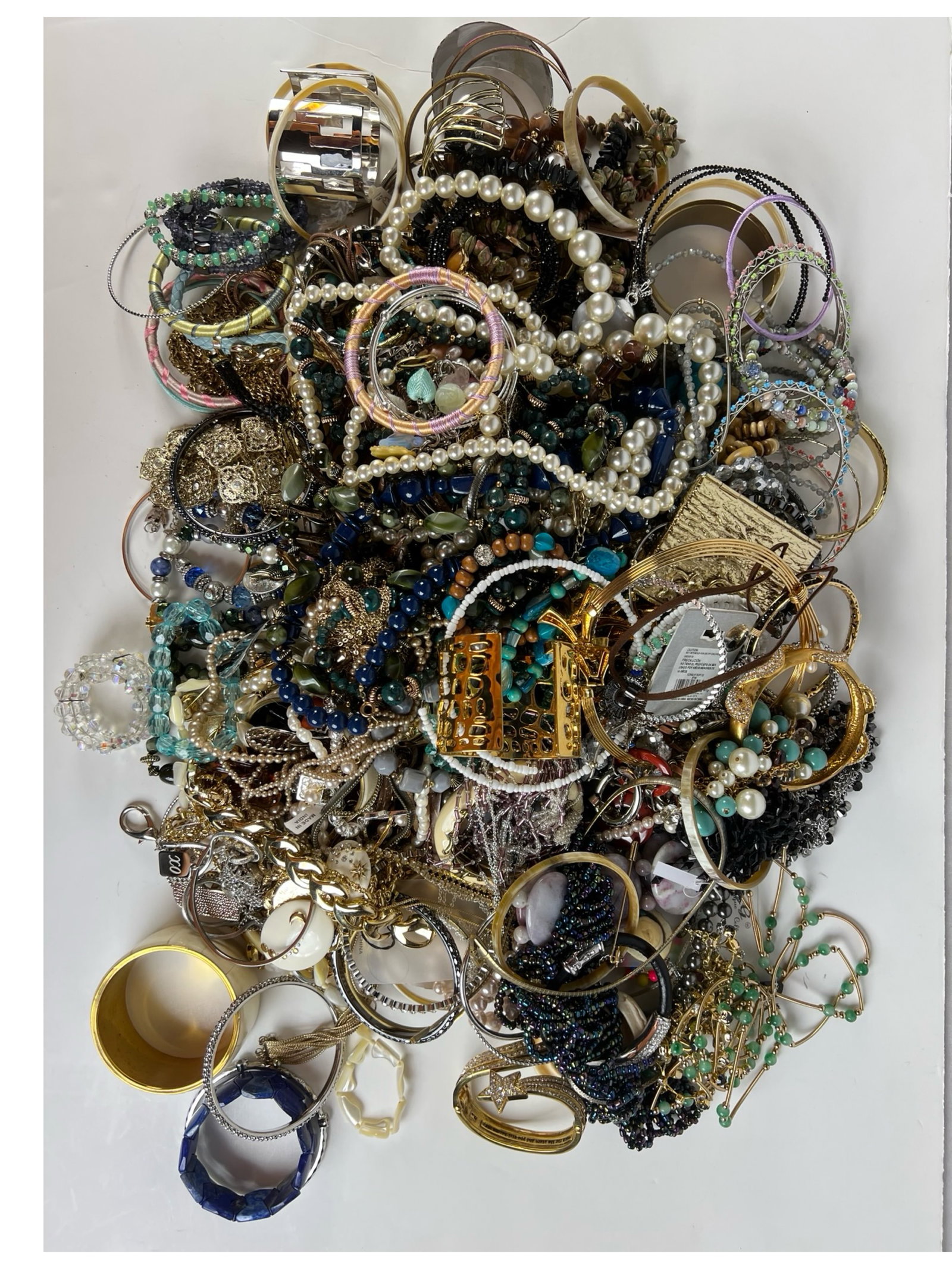 Over 12 lbs of Unsearched Costume & Craft Jewelry: This is a large lot weighing over 12 pounds of unsearched costume and craft jewelry. The collection includes a mix of bracelets, necklaces, earrings, and miscellaneous pieces, offering endless possibi