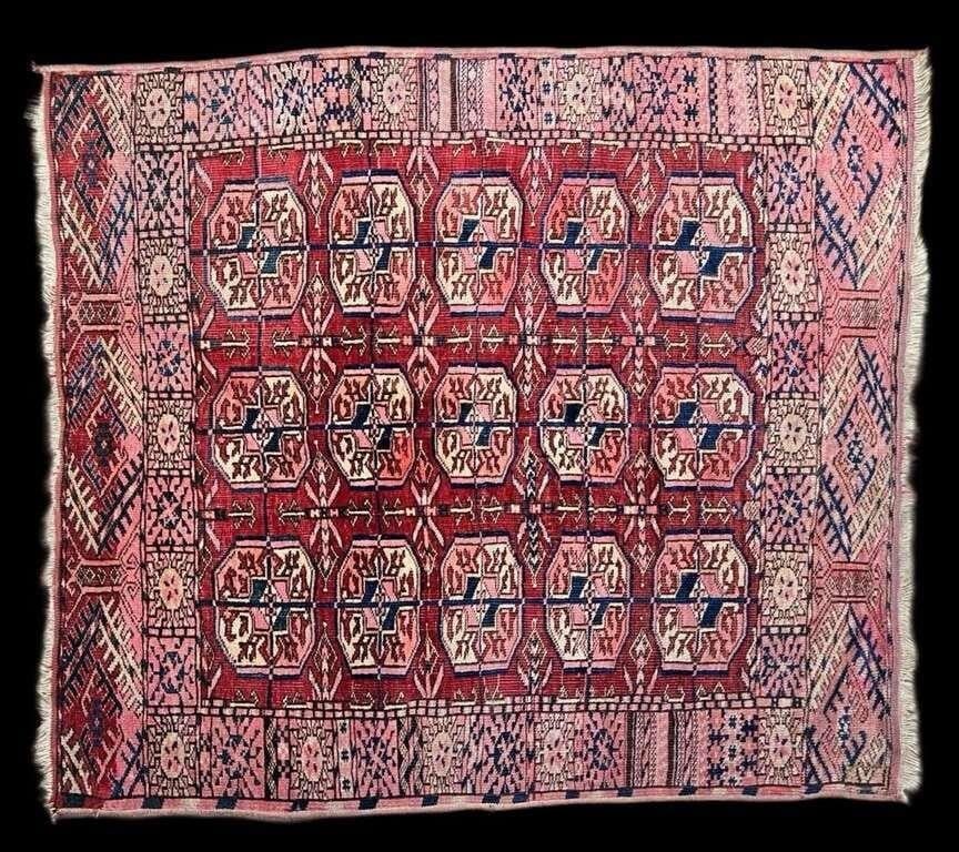 Vintage Turkmen Boukhara Rug Geometrical Design: This beautiful Turkmen Boukhara rug features a classic octagonal "gul" pattern, a hallmark of traditional Turkmen design, in shades of rich red, navy blue, and soft pink. Measuring 42" x 37", the rug 