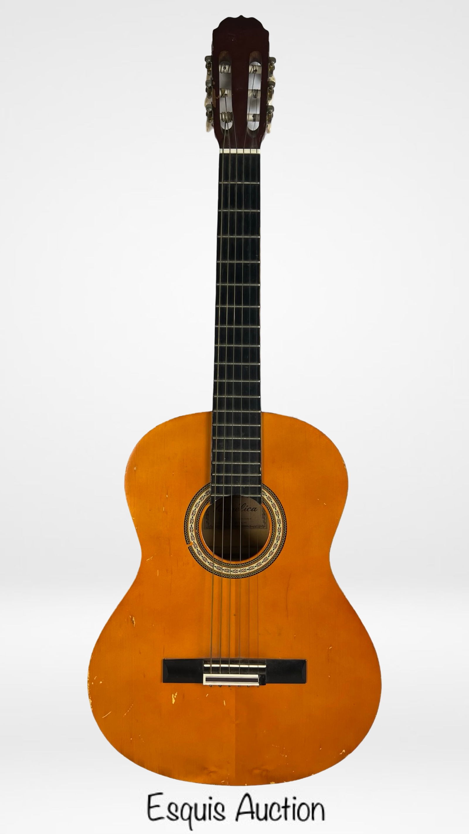 Angelica CG-112 Acoustic Guitar: Vintage Angelica CG-112 acoustic guitar. This guitar showcases a warm natural wood finish with intricate rosette detailing around the soundhole. Good overall condition showing some age related wear.