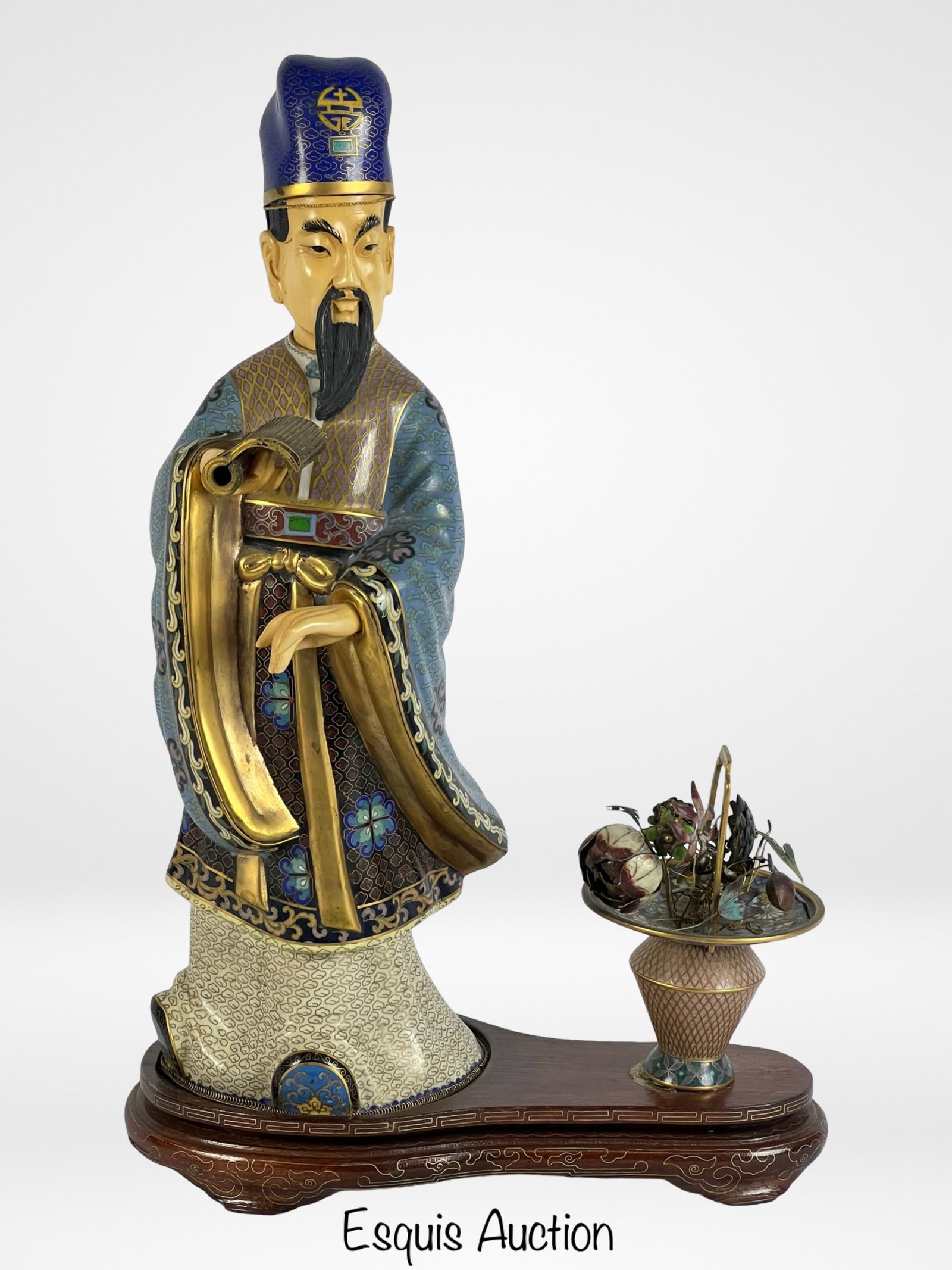 Antique Chinese Cloisonne Enamel Immortal Figure: Magnificent Chinese cloisonne figure of an immortal, standing on a wooden base and accompanied by a basket of flowers. The figure is richly adorned with detailed enamel work, including intricate flora
