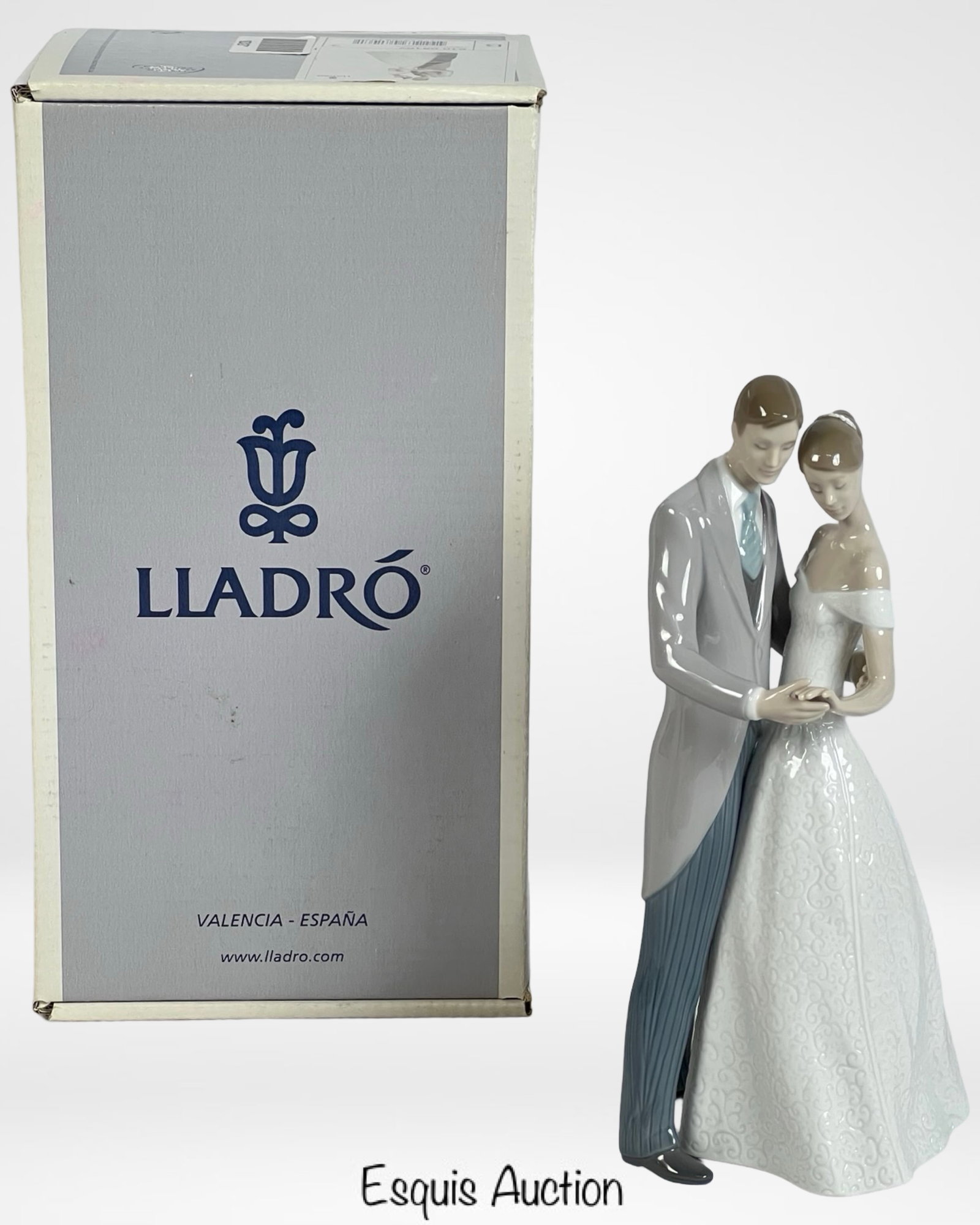 Lladro "Together Forever" 8107 Porcelain Figurine: Lladro "Together Forever" porcelain figurine (8107) depicts an elegant couple on their wedding day, capturing a moment of love and intimacy. The bride is adorned in a detailed lace-patterned gown, whi