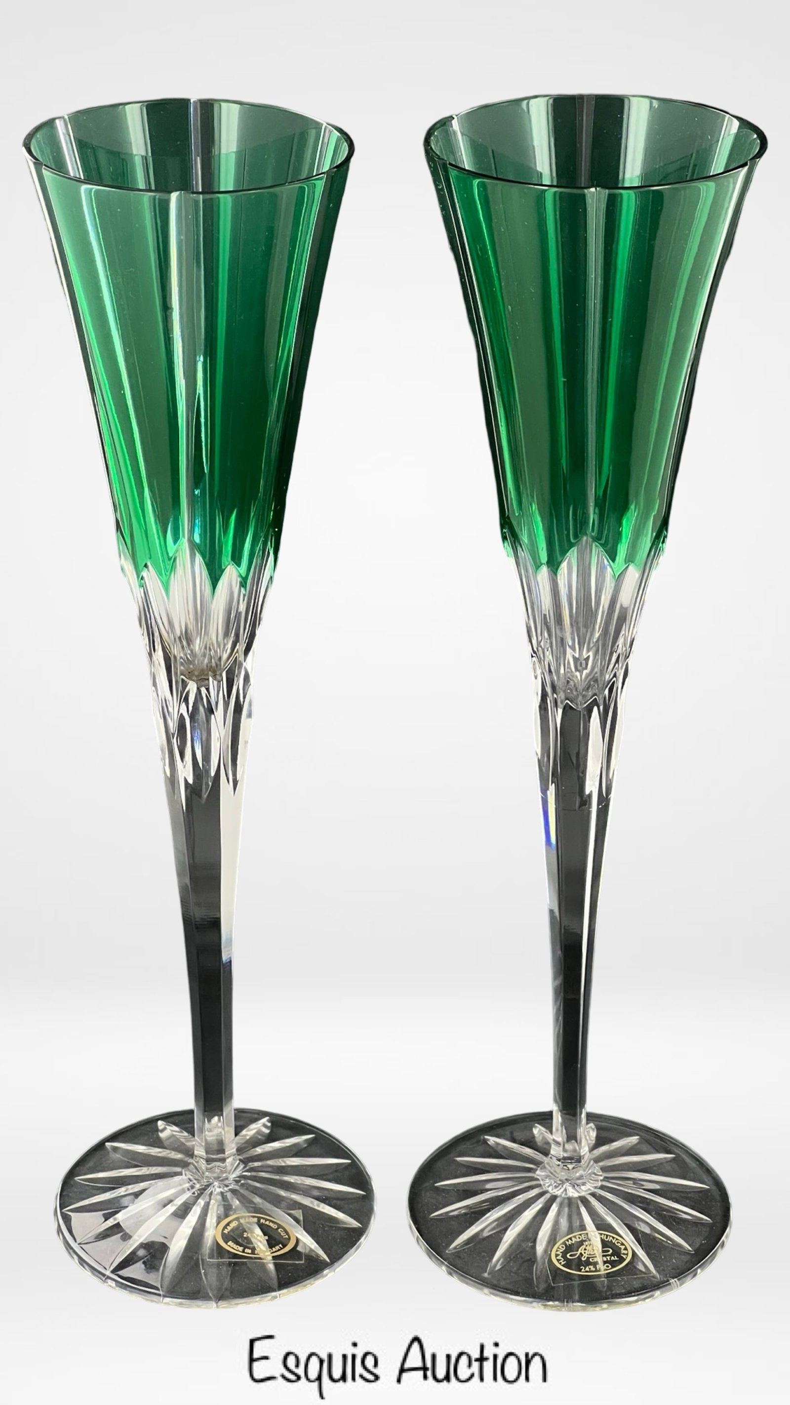Ajka Crystal Emerald Green Champagne Flutes: A stunning pair of Ajka Crystal Castille Albinka Cut to Clear Champagne Flutes in a rich emerald green. These exquisite flutes stand 10 inches tall and are handcrafted in Hungary from 24% lead crystal