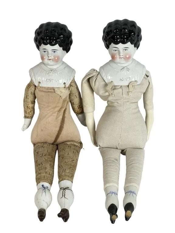 Antique German China Head Dolls - Agnes & Bertha: Pair of antique German china head dolls featuring the traditional black molded hairstyles.Both are approx. 21" tall. Good overall condition with no cracks or repairs.