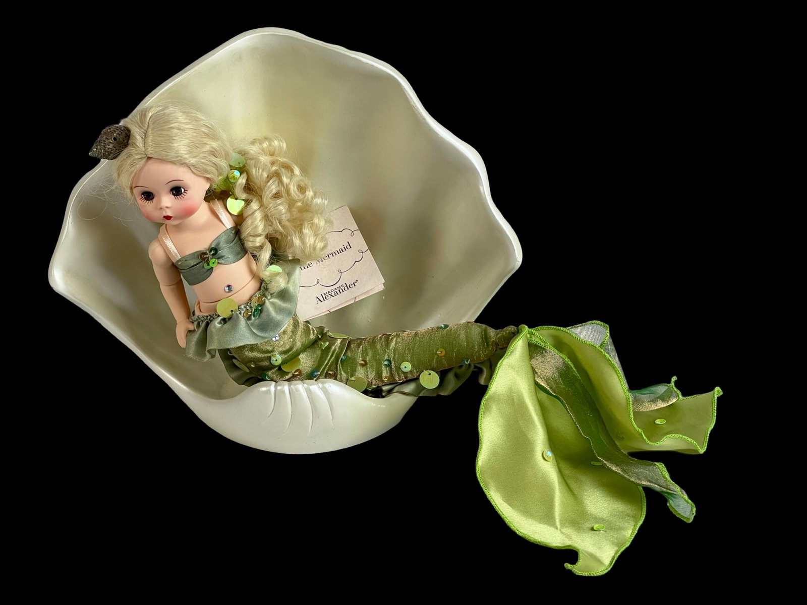 Madame Alexander Disney Little Mermaid Doll: A charming 8" Madame Alexander Disney Little Mermaid doll, beautifully dressed in a shimmering green mermaid outfit adorned with sequins and a satin tail. Features blonde curls and includes an elegant