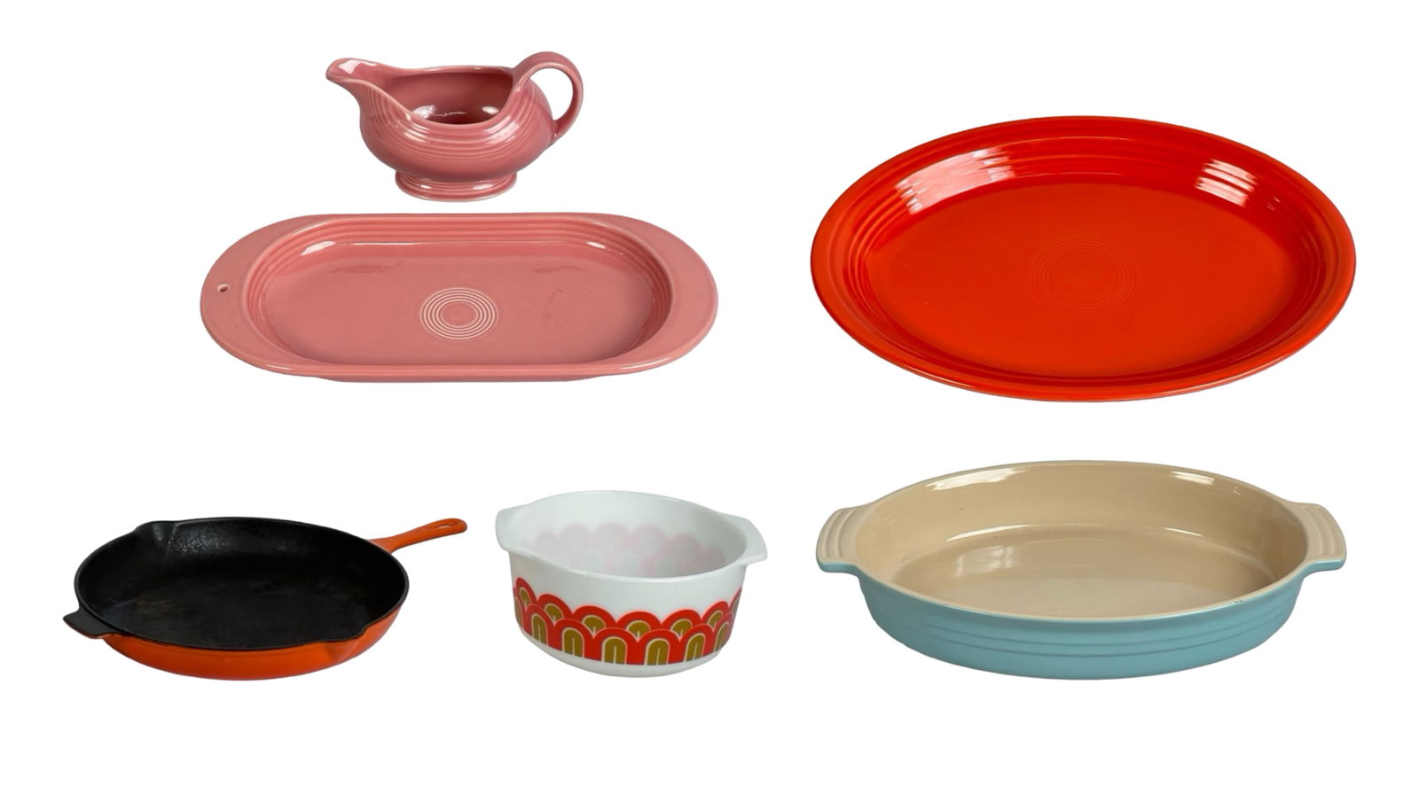 Colorful Kitchenware- Le Creuset, Pyrex, Fiesta: This vibrant kitchenware lot includes a variety of high-quality items from renowned brands. The set features a pink Fiesta gravy boat and matching platter by Nora Fleming, a bright orange Le Creuset c