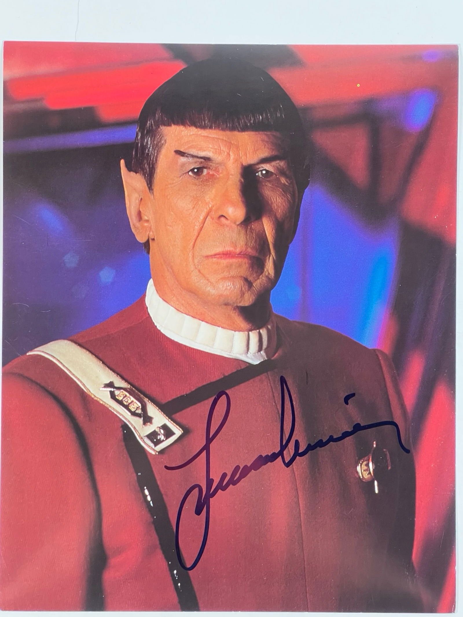 Leonard Nimoy Signed Spock Star Trek Photograph: Autographed 8" x 10" photograph of Leonard Nimoy as Spock from Star Trek. This vibrant image captures Spock in his Starfleet uniform, signed in bold black ink across the lower portion of the photograp