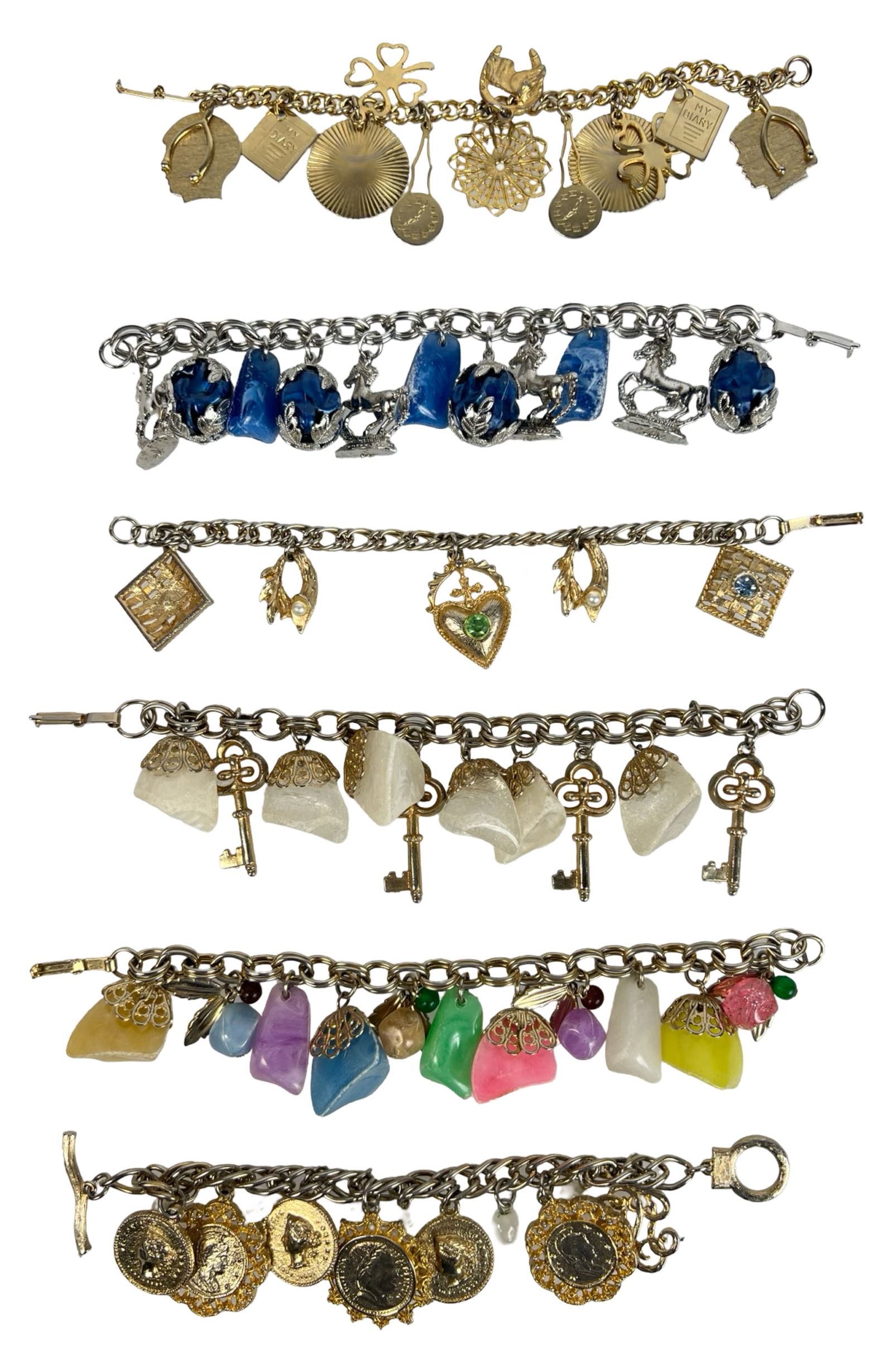 Group of Vintage Charm Bracelets: Lot of six vintage charm bracelets featuring an eclectic mix of metals, stones, and themed charms. Includes gold-tone and silver-tone chains adorned with unique elements such as glass cabochons, horse