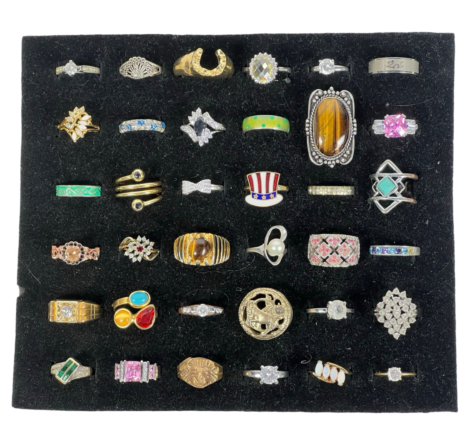 Exquisite Collection of 36 Lady's Rings: An exquisite collection of 36 lady's rings, each showcasing unique designs, styles, and settings. This assortment features a variety of materials and stones, including simulated gemstones, intricate f