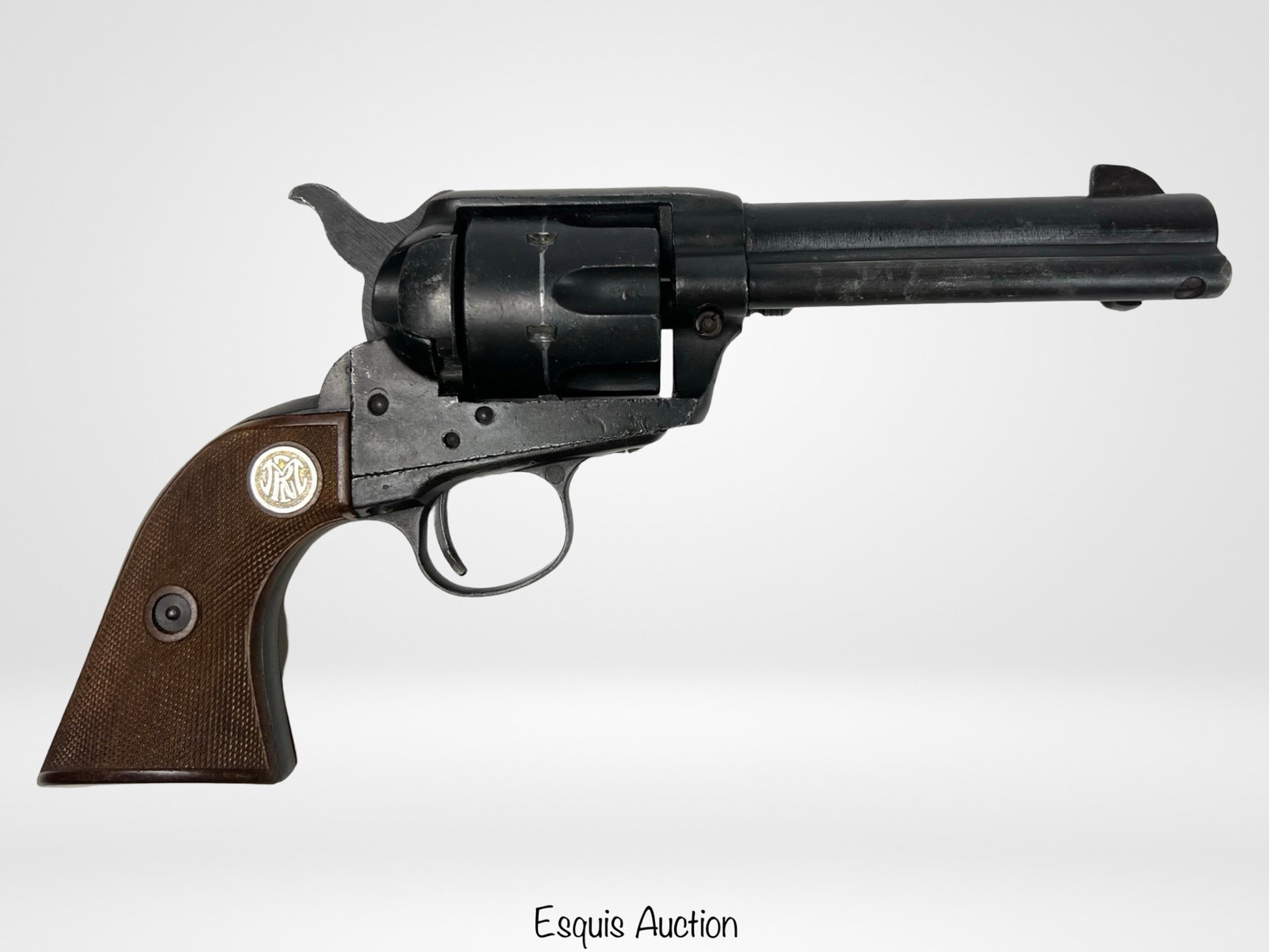 MGC Frontier Six Shooter Revolver Prop Gun Replica: Vintage MGC Manufactory Frontier Six Shooter, a detailed replica of the classic 44-40 caliber revolver. Designed as a prop gun, this piece features a black finish with wooden-style grips embossed with