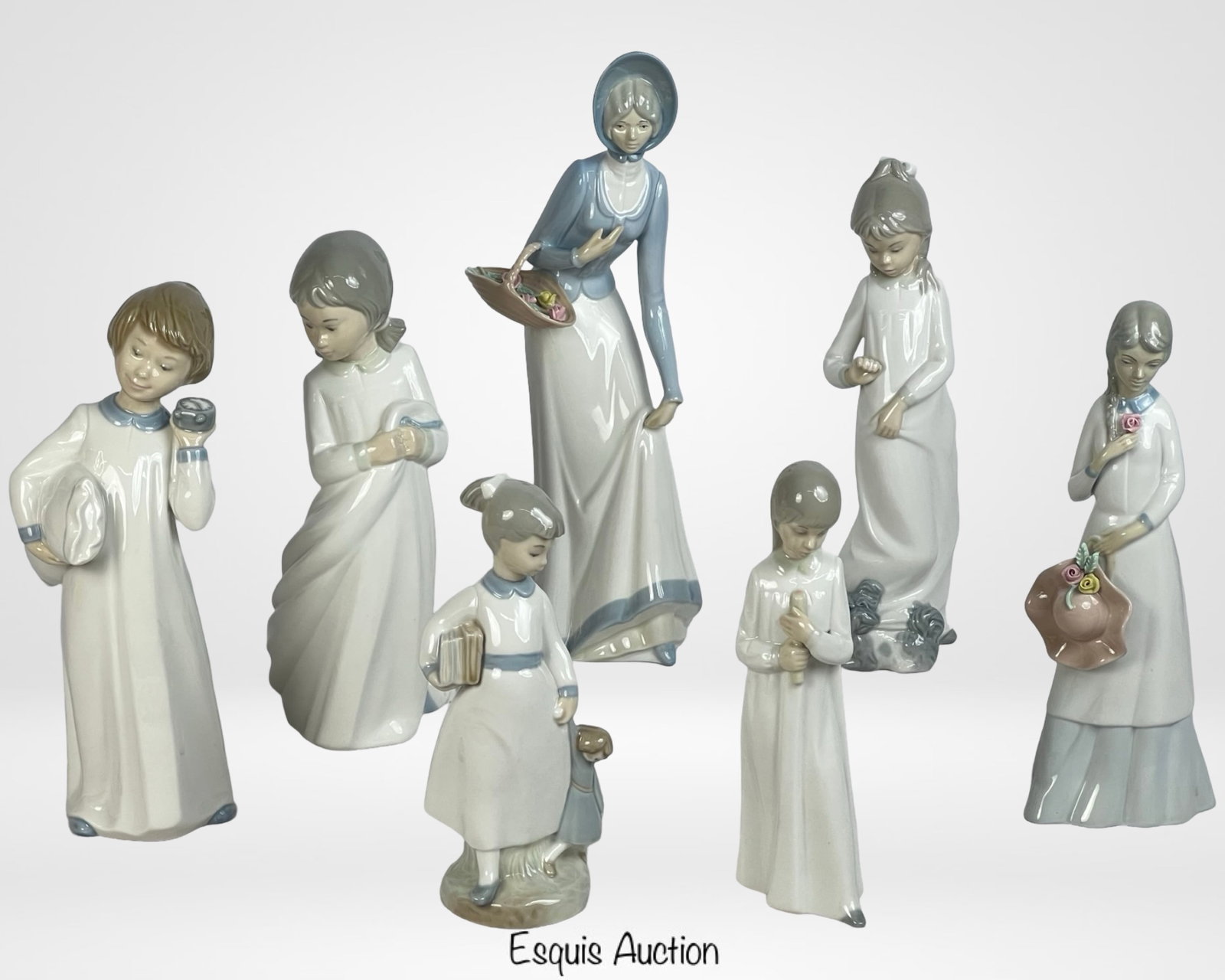 Set of Four Lladro-Like Porcelain Figurines: A charming collection of four Lladro-style porcelain figurines, each crafted with delicate details and serene expressions. Measurements range from 6" to 9.5" tall. A beautiful decorative addition to a
