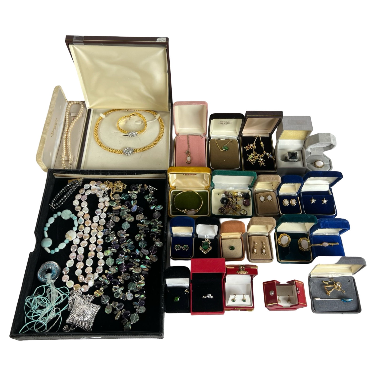 Assortment of Vintage and Contemporary Jewelry: Diverse collection of jewelry including necklaces, earrings, bracelets, and rings, featuring an array of styles from vintage to contemporary. Highlights include pearl strands, gemstone-adorned pieces,