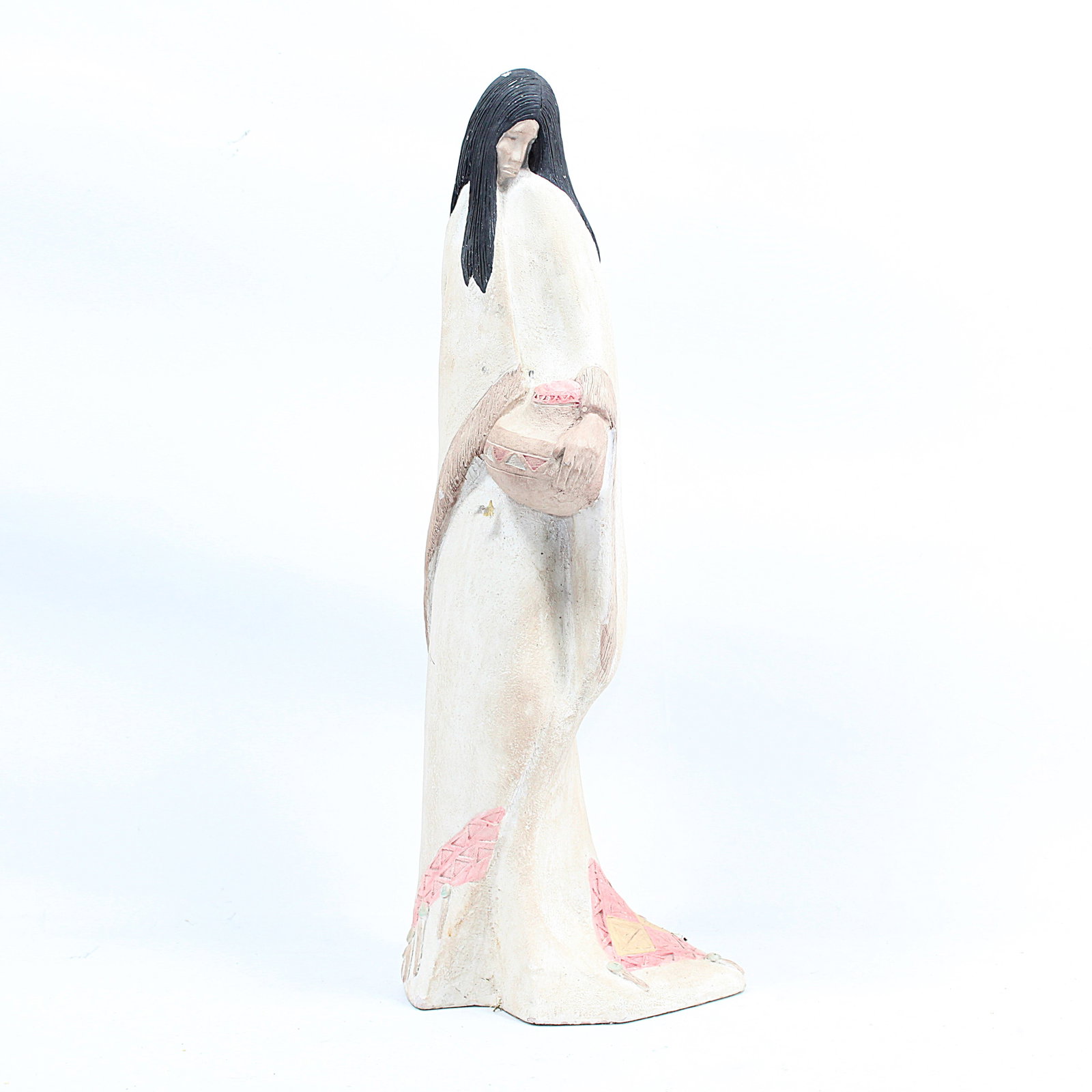 Native American Woman Figurine: Beautifully crafted sculpture depicting a Native American woman wrapped in a shawl, holding a basket. The figure exudes elegance with soft earth tones, intricate detailing, and traditional geometric a
